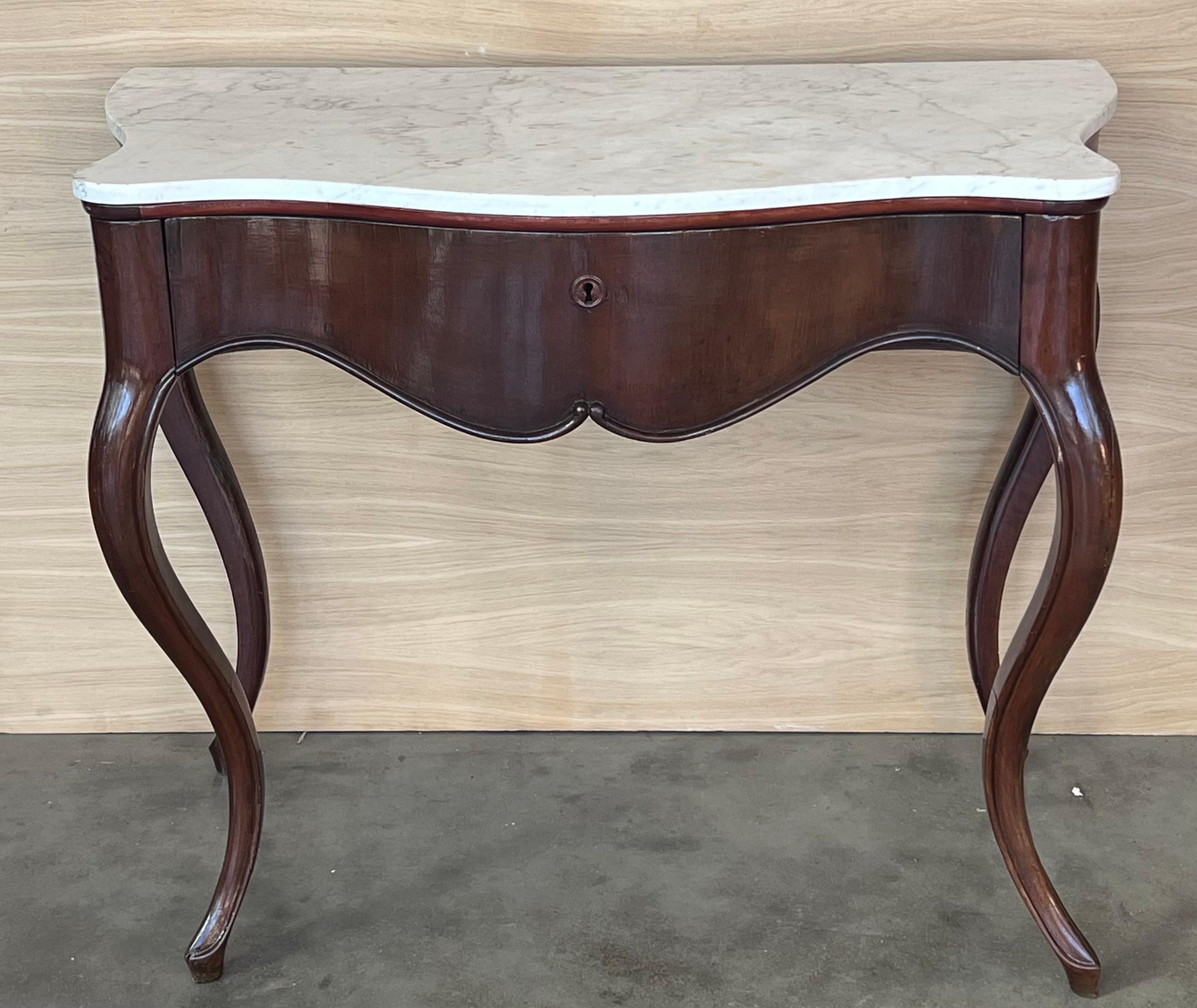 19th French Regency carved walnut console table with drawer & marble top

19th century French Regence style. White cream marble top with front drawer, over hand-carved frieze supported by four cabriole legs Massive and stabile console in very good