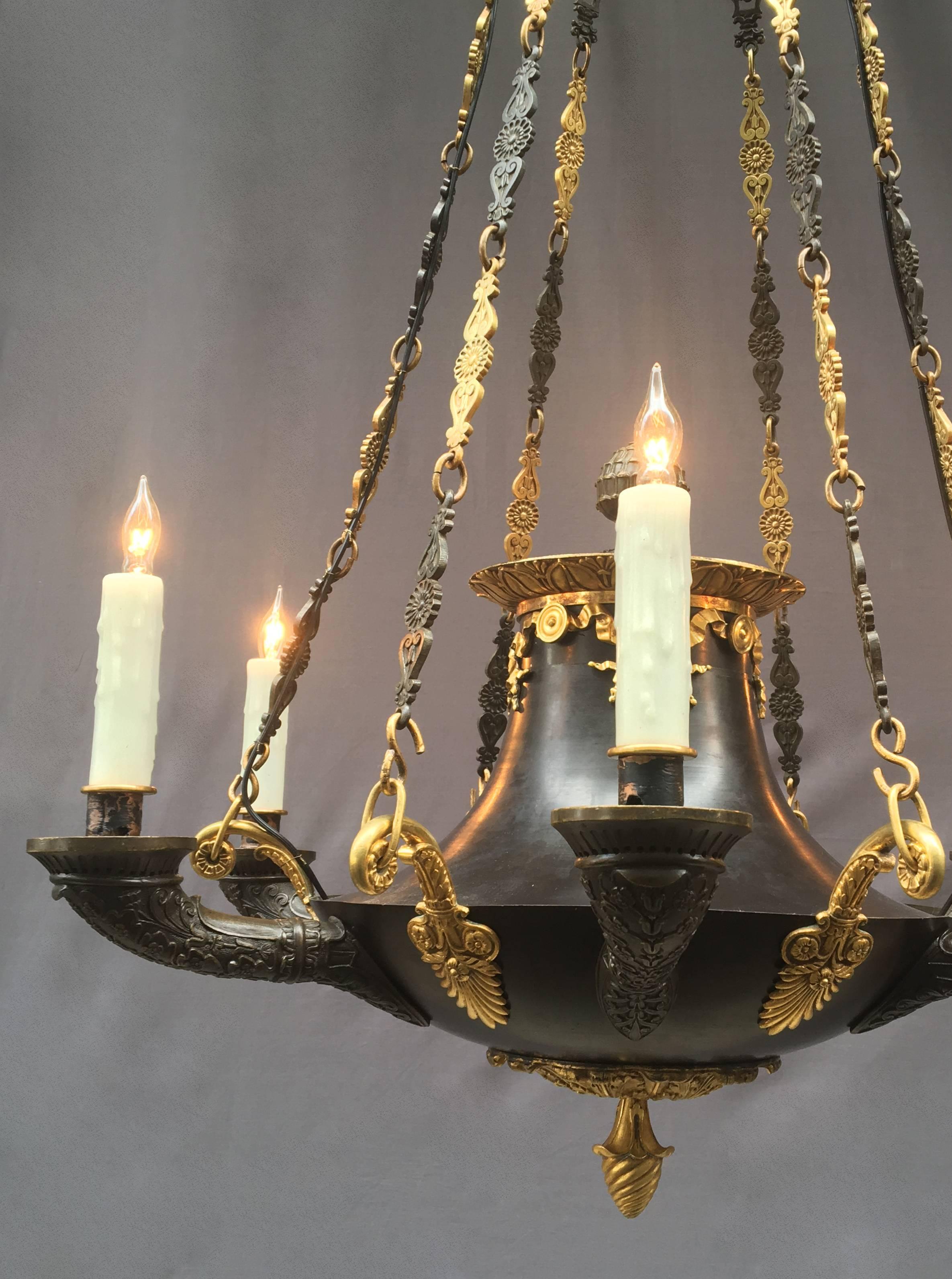 1830s patinated bronze and ormolu candle chandelier. This chandelier is an important piece of Texas history being deaccessioned from the Bayou Bend Collection. The chandelier originally hung in the Chillman Parlor in Bayou Bend assembled by Miss.