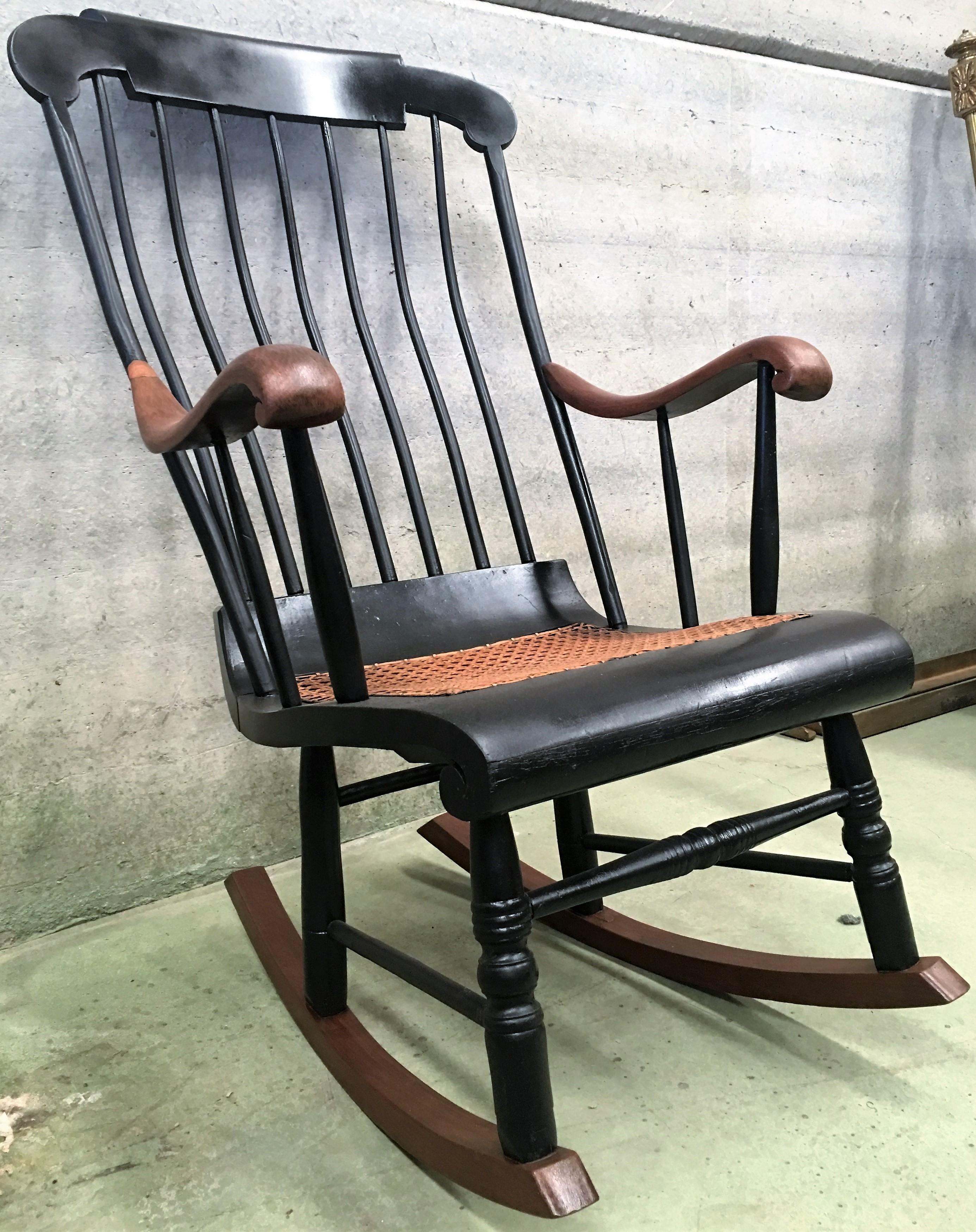 19th Hitchcock rocking chair with woven seat and black painted.