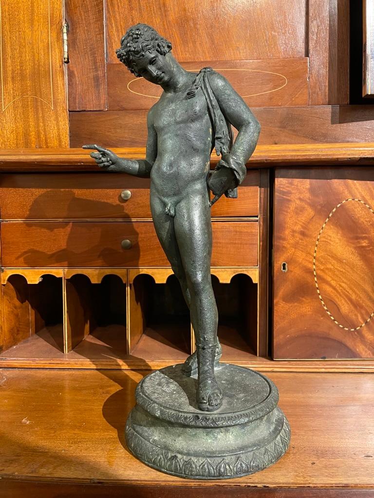 19th century Italian Grand Tour bronze of Narcissus standing and gazing at his reflection after the ancient Roman original excavated at Pompeii in 1862, now at the Archaeological Museum of Naples.
Shown naked but for the animal skin on his shoulder