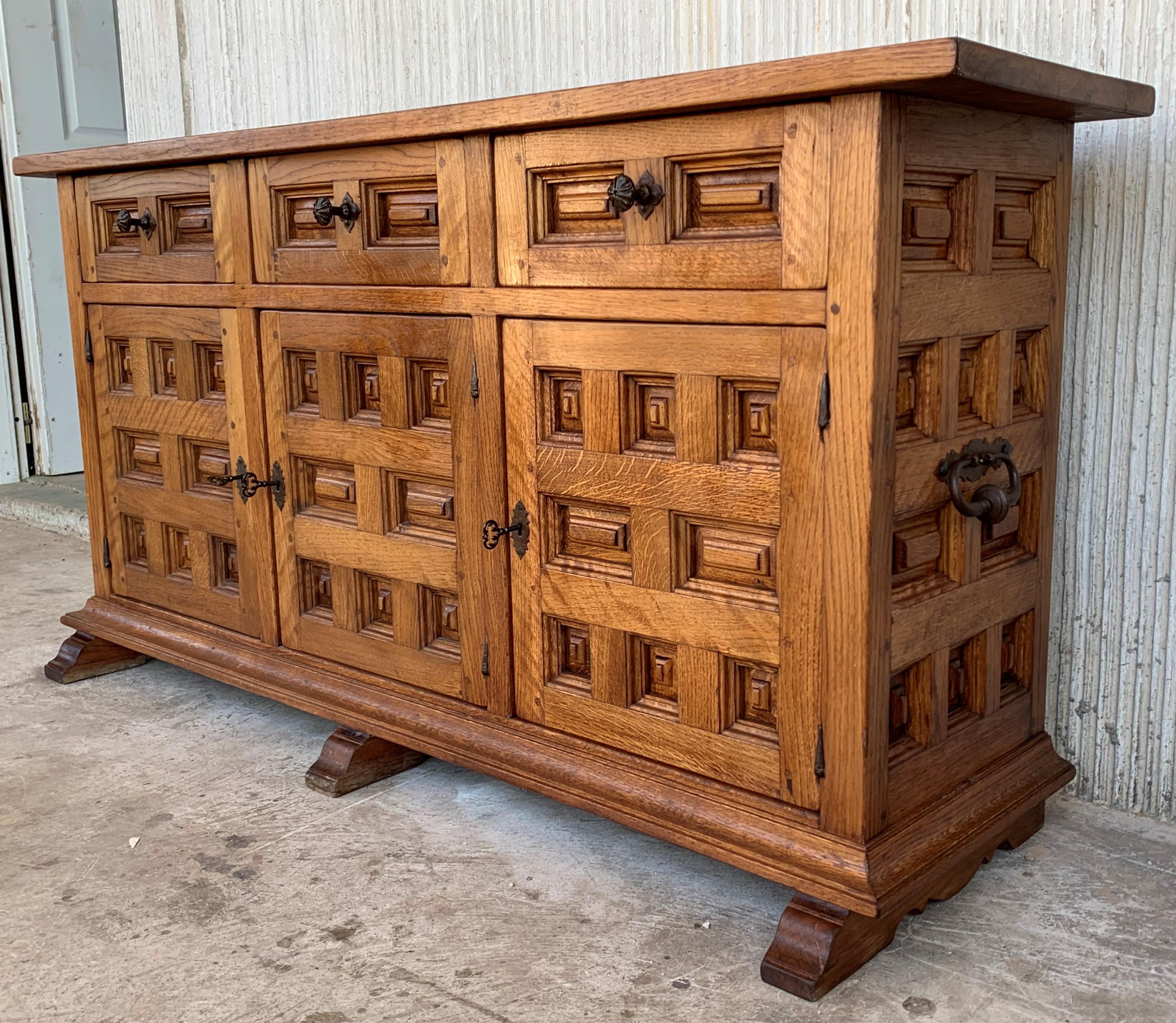 From Northern Spain, constructed of solid oak, the rectangular top with molded edge atop a conforming case housing three drawers over three doors, the doors paneled with solid oak, raised on a plinth base.
Very heavy and original cabinet.
  