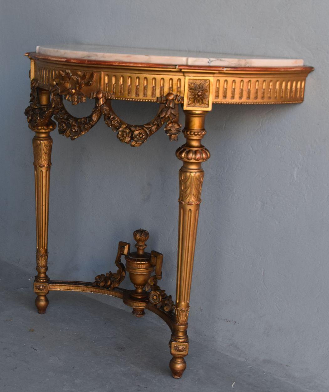 Louis XVI Style giltwood wall console in 19th century pink marble top, height 97 cm, width 100 cm and depth 50 cm.