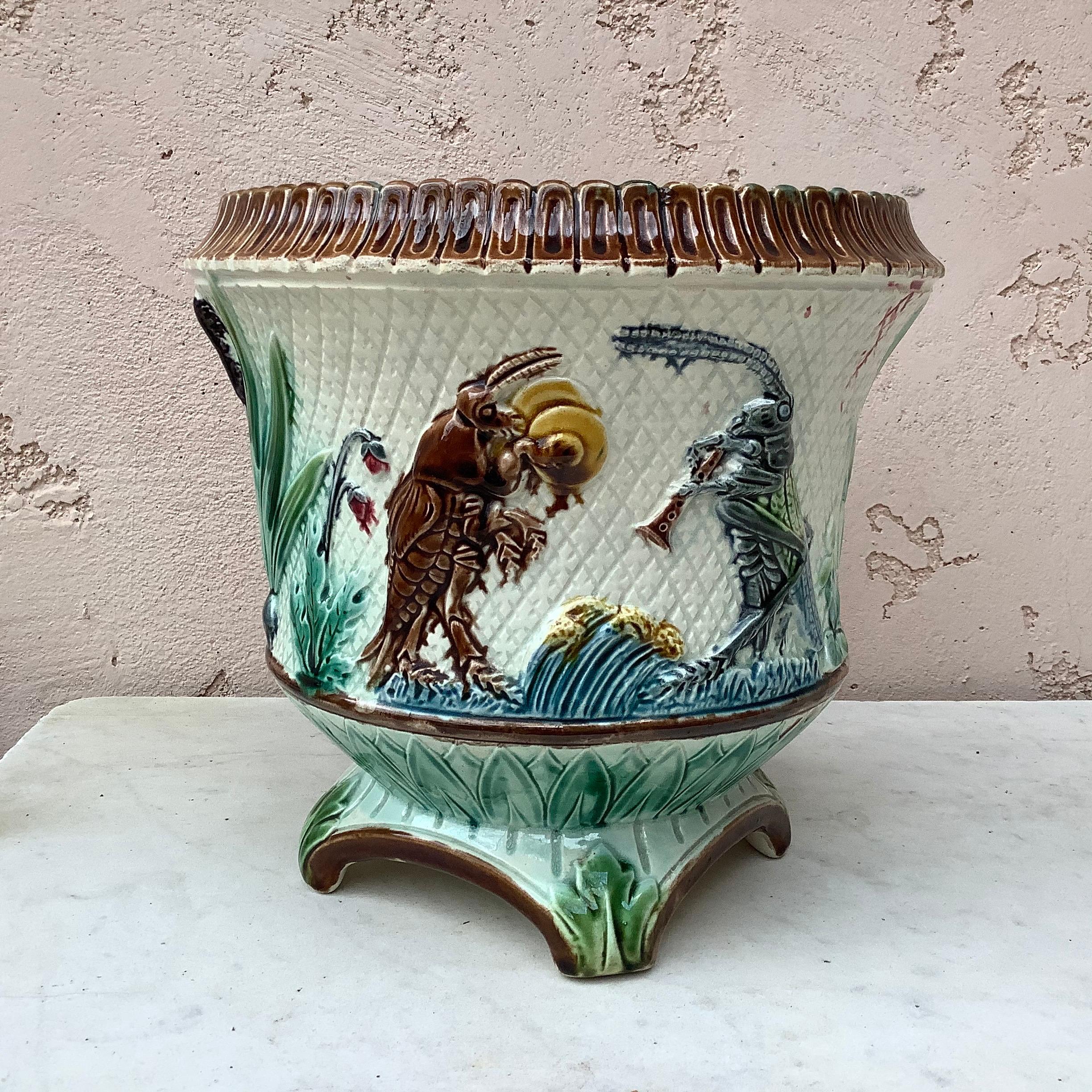 Unusual and humoristic 19th century French Majolica cache pot planter with insects playing musicals instruments.
Decorated with leaves and flowers.