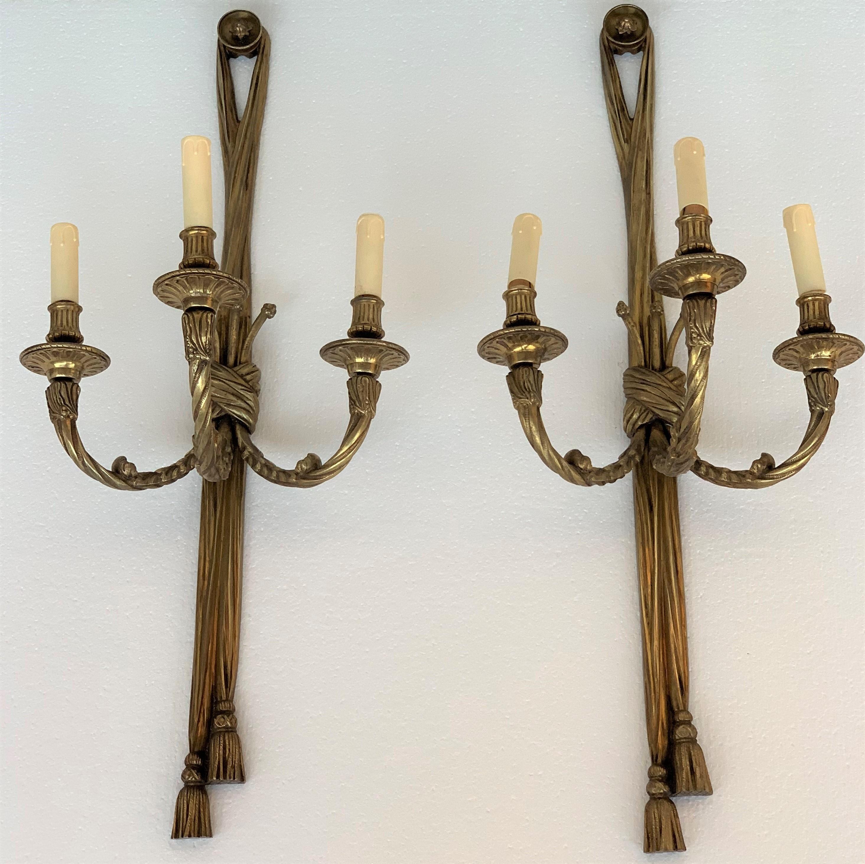 19th century neoclassic gilt bronze sconces with three lamps.
 