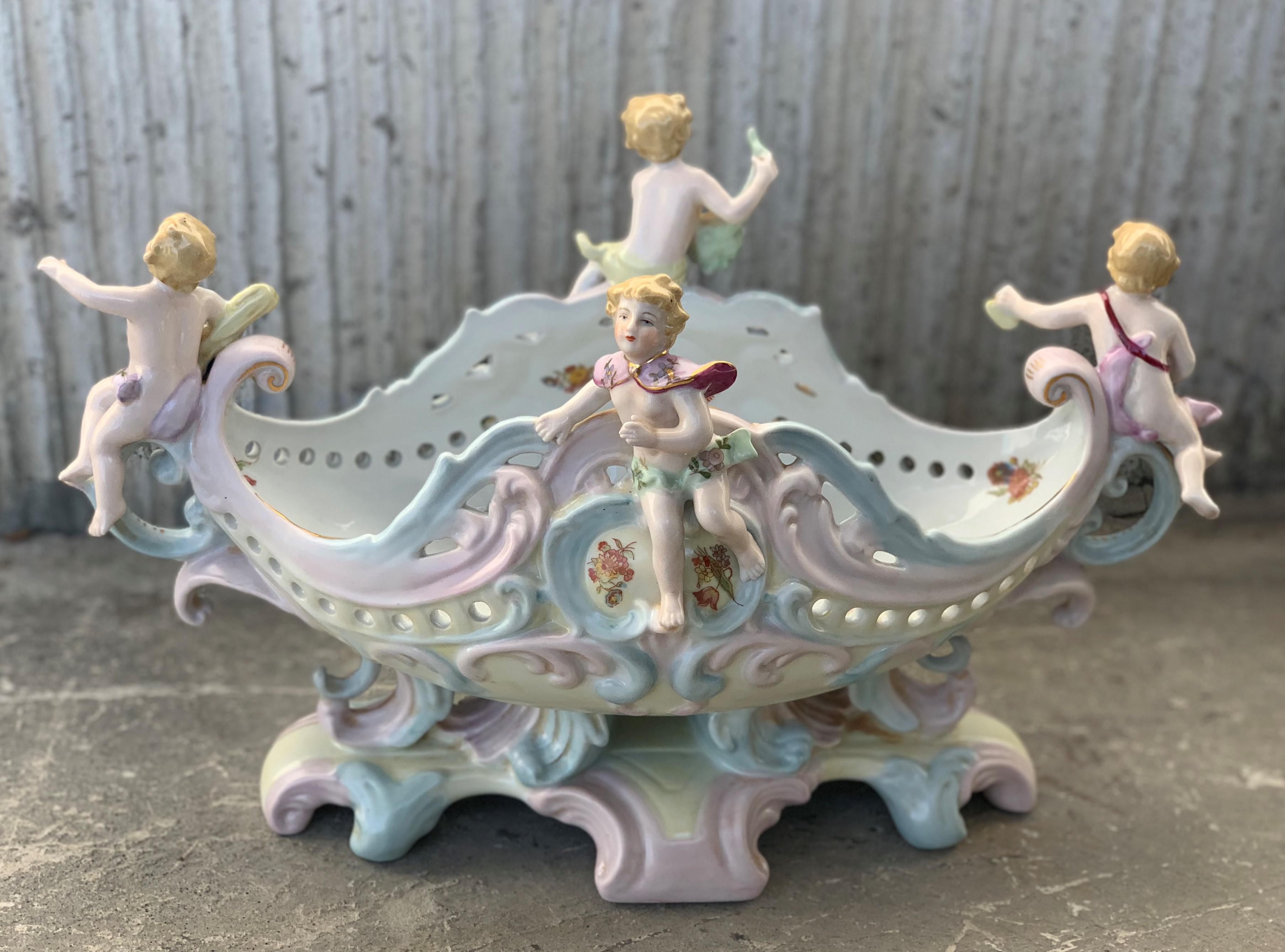 19th century Austrian porcelain centerpiece bowl or jardinière beautifully enameled in rich colors with floral sprays and gilt highlights. This stunning Rococo piece heavily Meissen piece also features encrusted flowers, leaves and ribbon with four