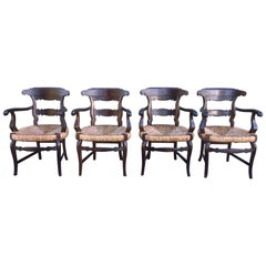 XIX Conjunto de cuatro sillones anglosajones con amplios asientos de caña