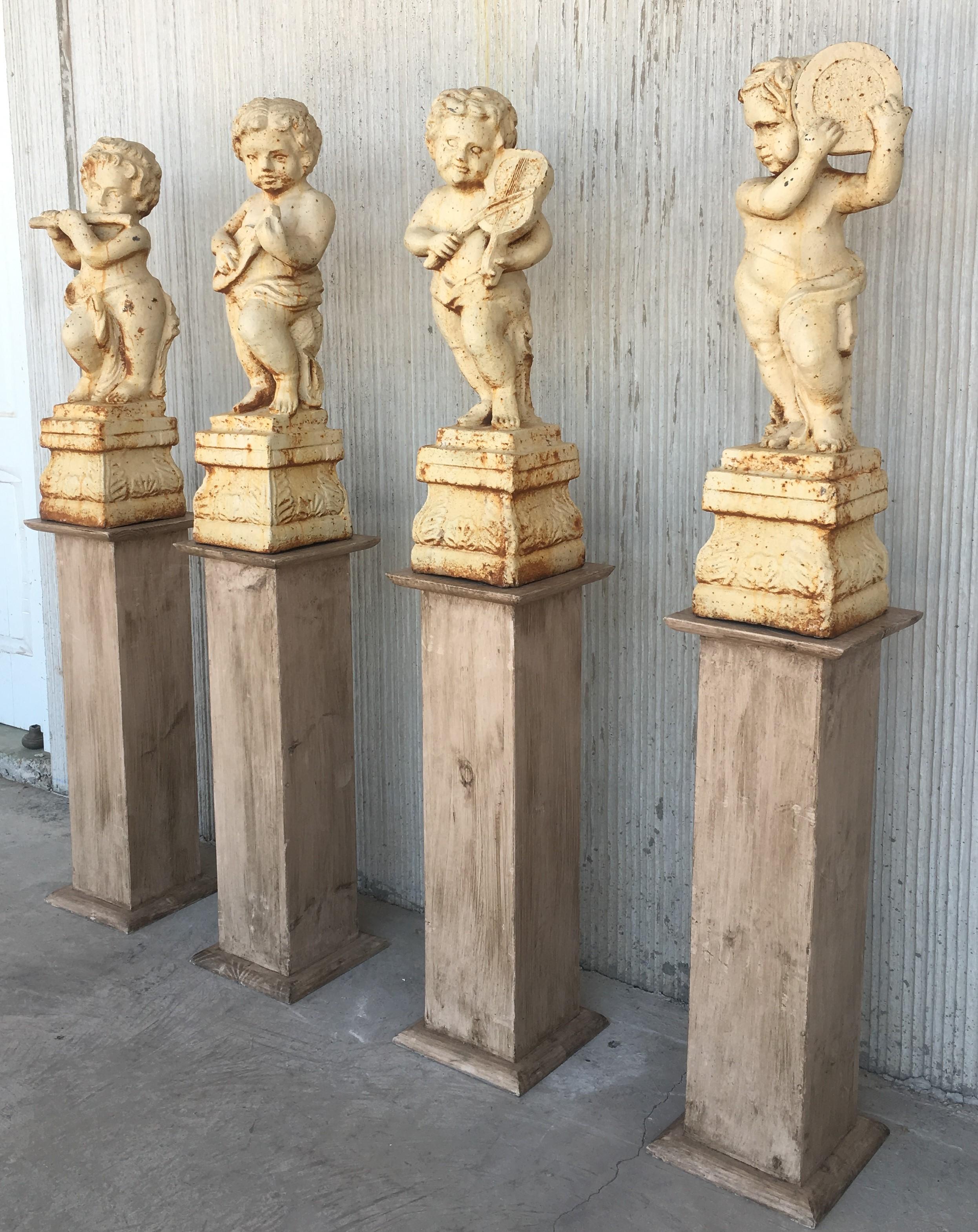 19th set of four cast iron Fiske Cherubs boy garden statues with stands.

Cherub garden statue attributed to Fiske Foundry, circa 1870s. Great original surface with traces of old white paint surface. 
Boy lifts off base for ease in moving. Very