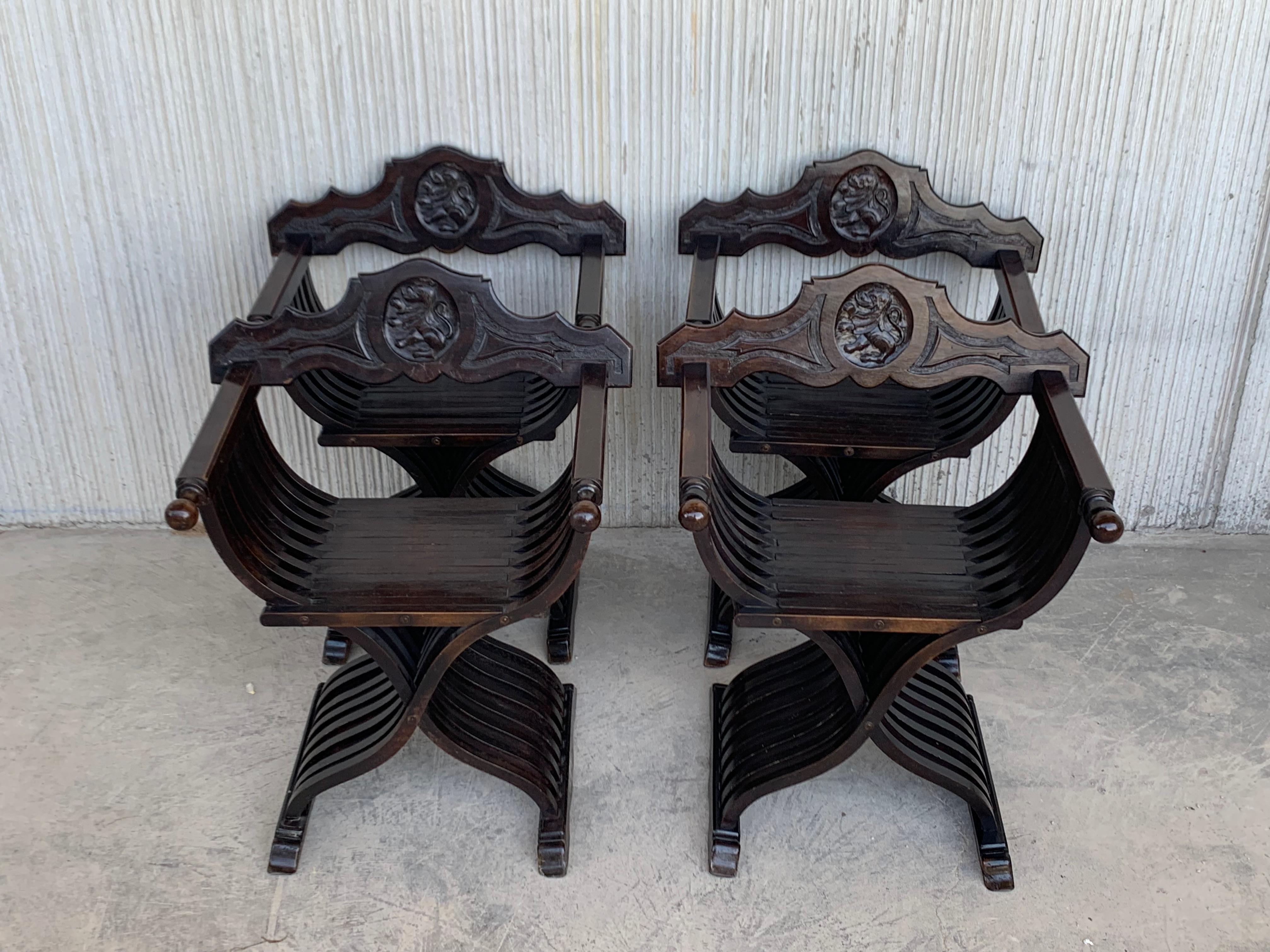 19th century carved walnut folding scissors Savonarola bench/settee featuring a lion shield in the back.

Typical of the Italian Renaissance with carved Florentine backs (no shows in the picture).
 This pair created in the 19th century, most likely