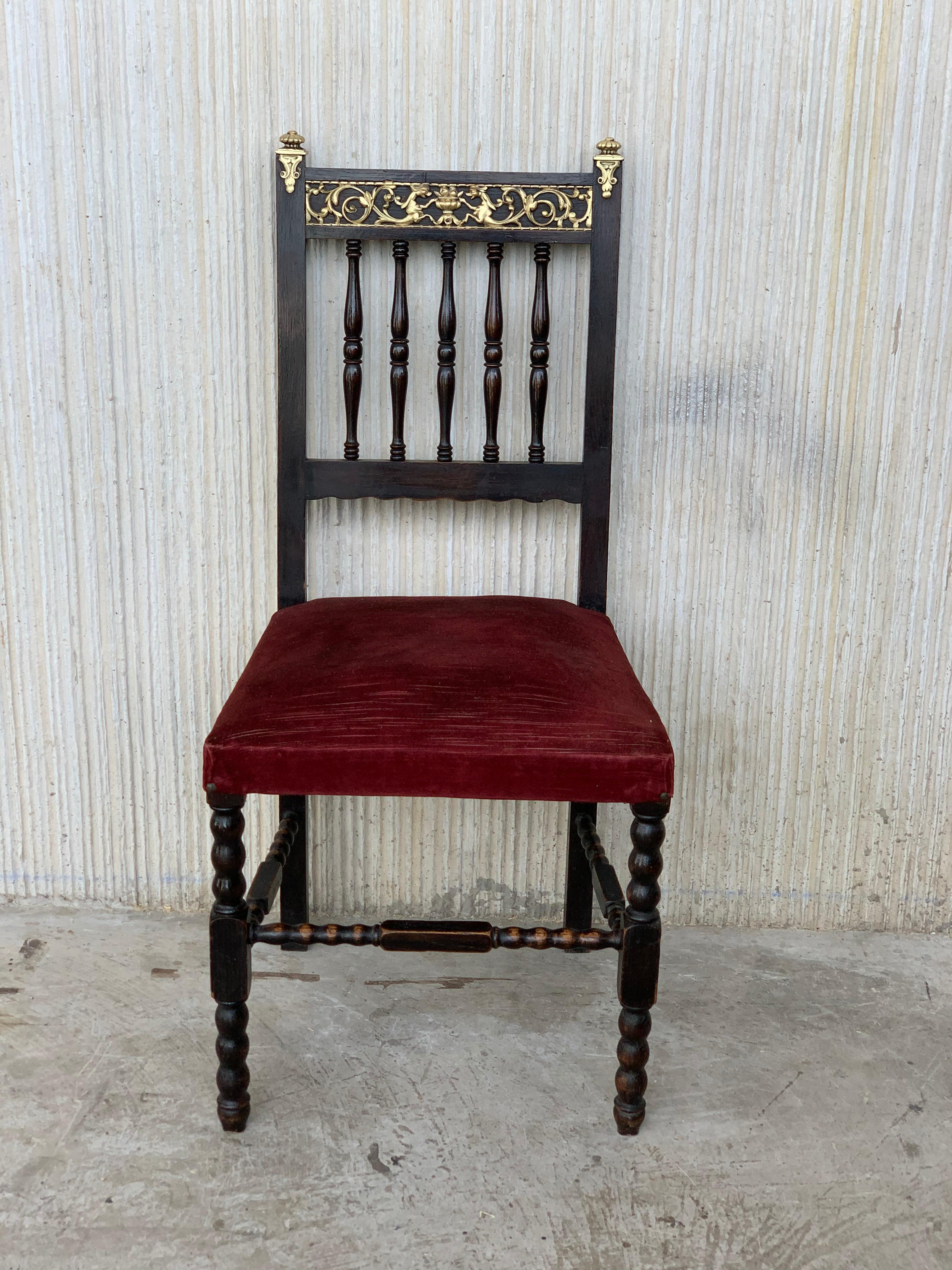 19th set of six Spanish chairs with bronze details and red velvet upholstery.
 