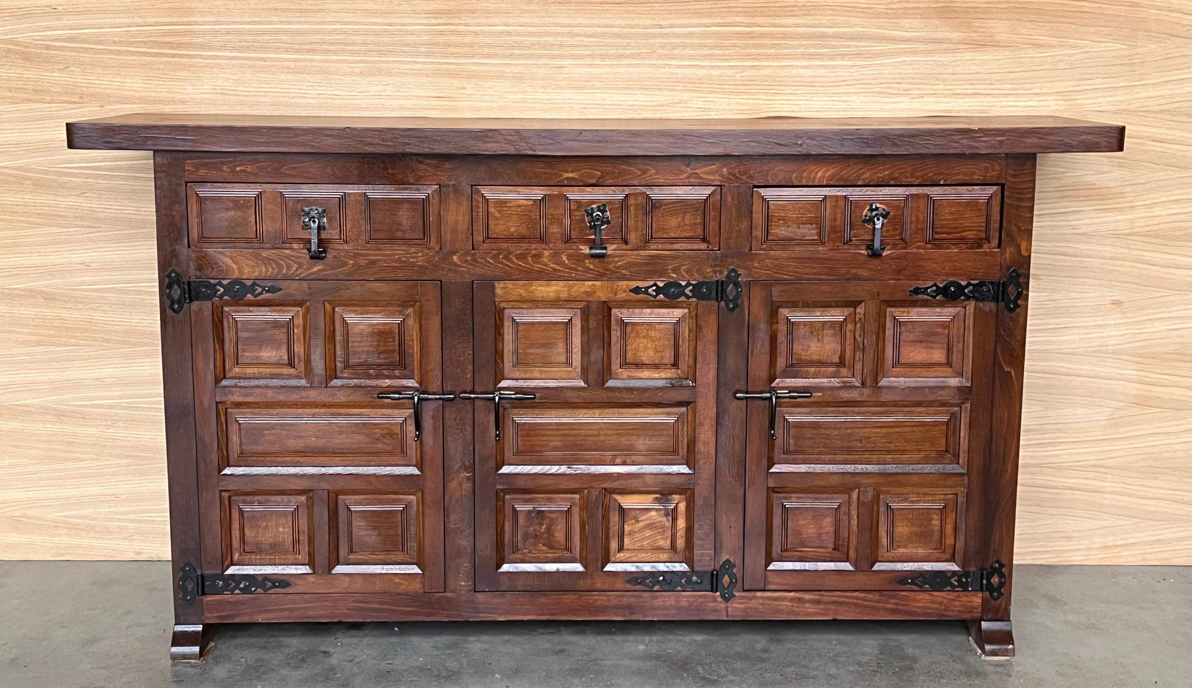 From Northern Spain, constructed of solid walnut, the rectangular top with molded edge atop a conforming case housing two drawers over two doors, the doors paneled with solid walnut, raised on a plinth base.
Beautiful carved drawers and original