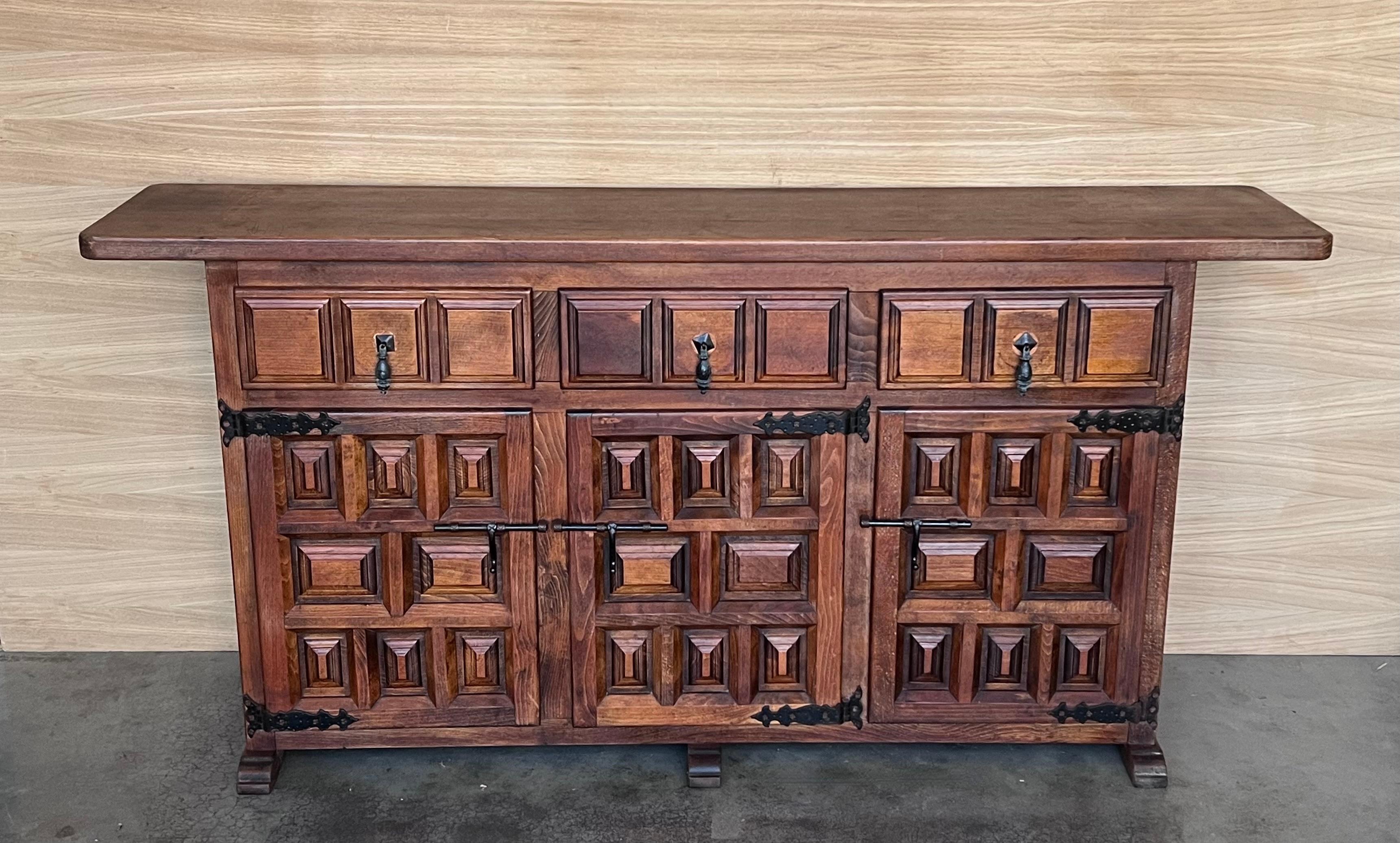 From Northern Spain, constructed of solid walnut, the rectangular top with molded edge atop a conforming case housing two drawers over two doors, the doors paneled with solid walnut, raised on a plinth base.
Beautiful carved drawers and original