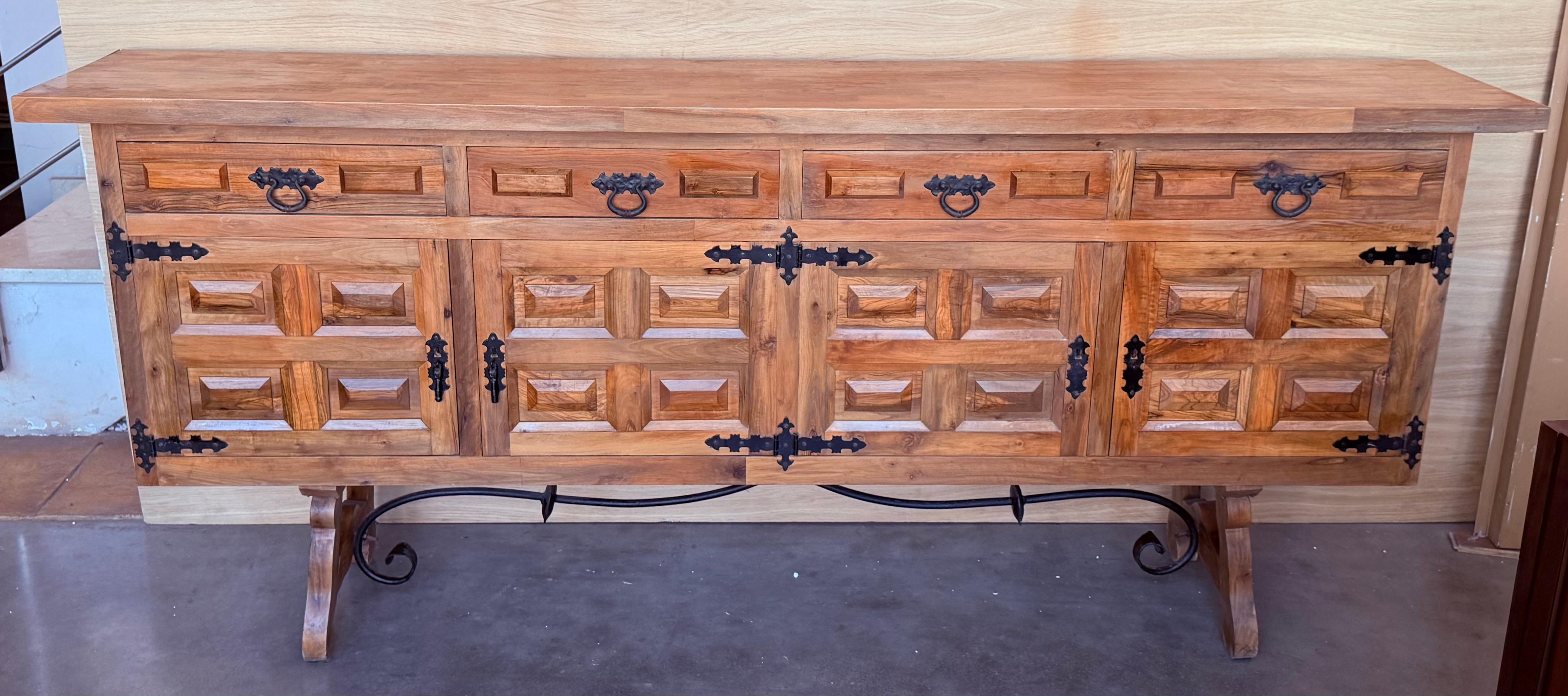 From Northern Spain, constructed of solid walnut, the rectangular top with molded edge atop a conforming case housing two drawers over two doors, the doors paneled with solid walnut, raised on a plinth base.
Beautiful carved drawers and original