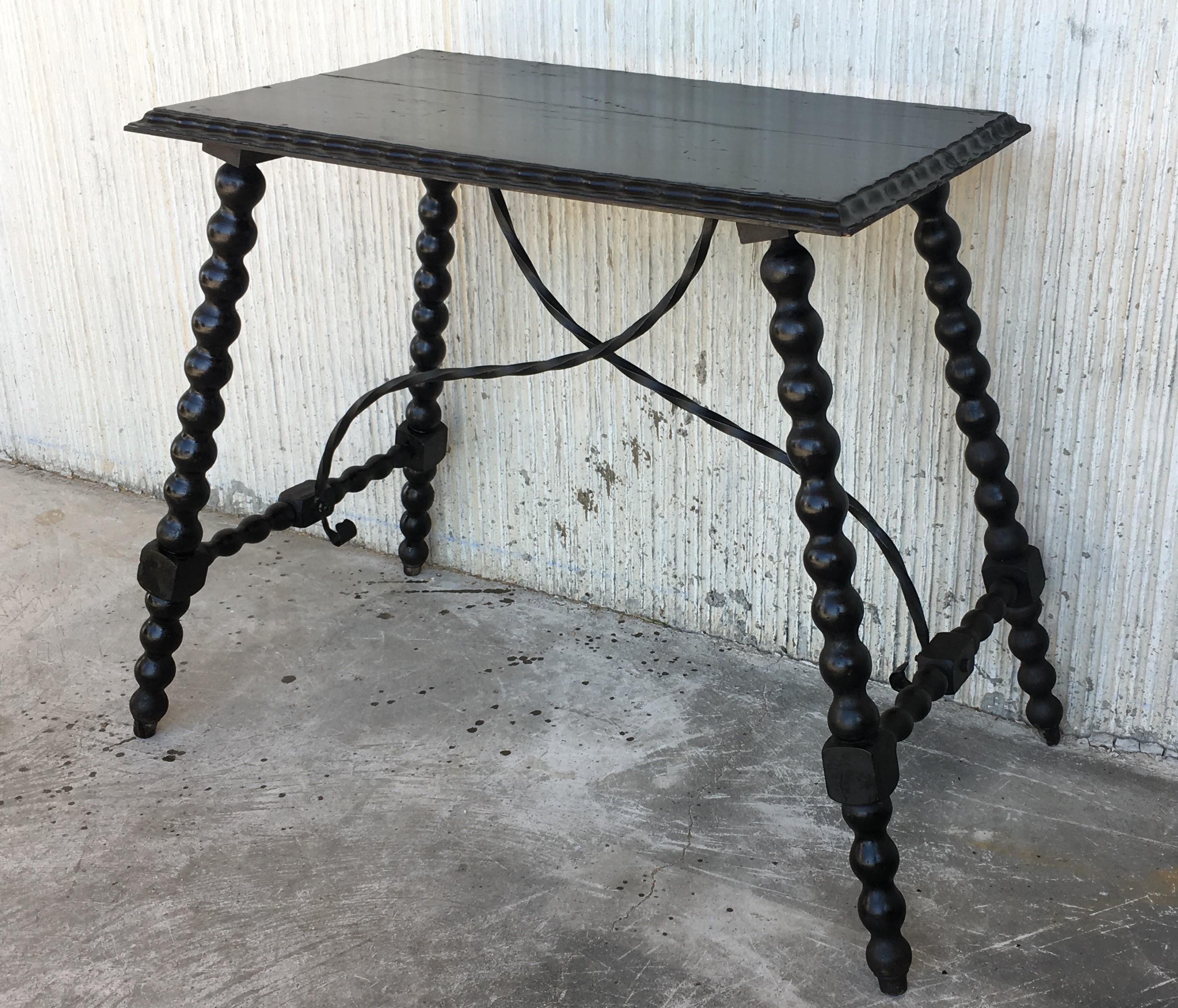 19th century Spanish Baroque ebonized side table with iron stretcher and carved top in walnut.