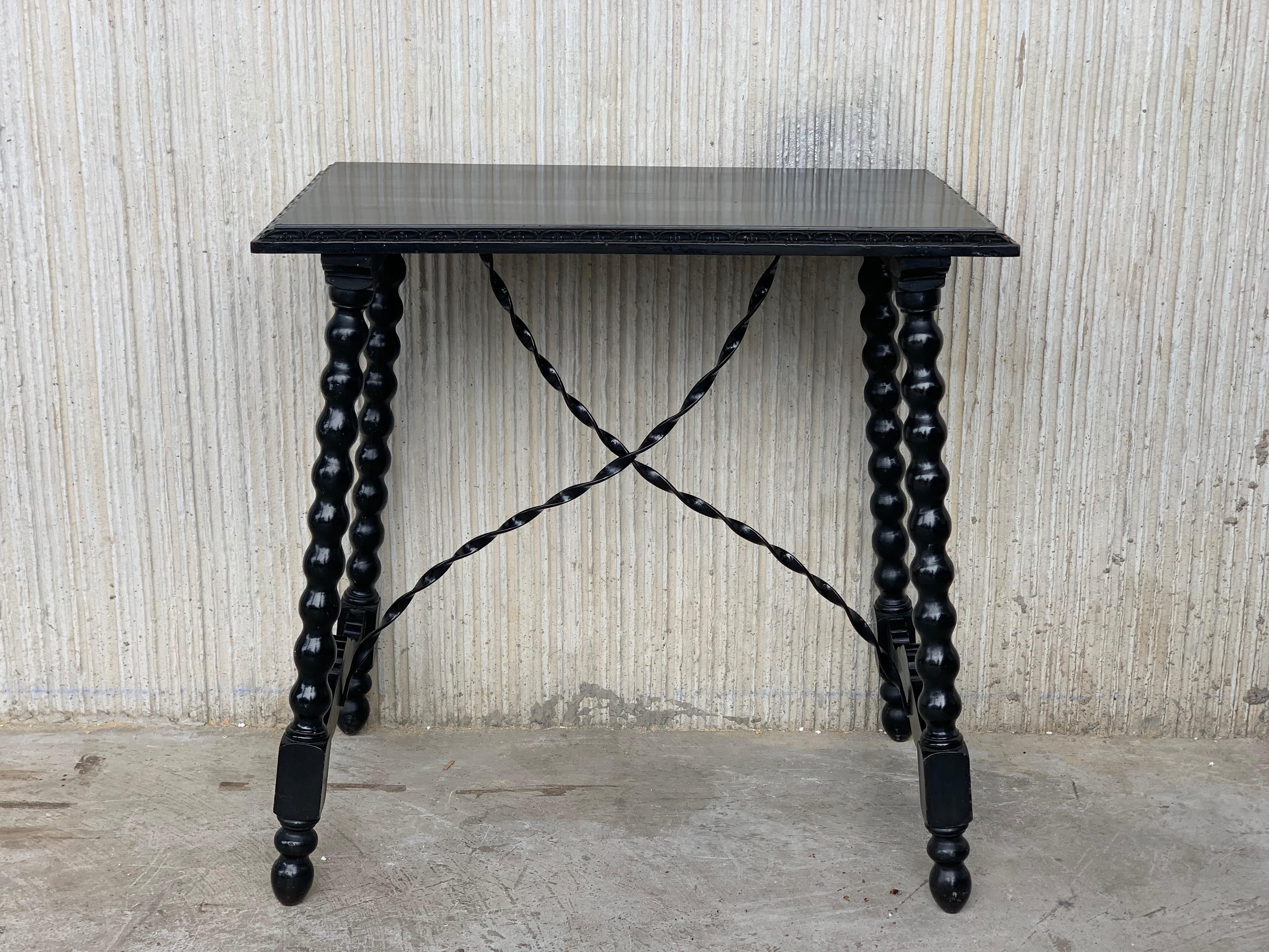 20th century Spanish baroque ebonized side table with iron stretcher and carved top in black ebonized walnut.