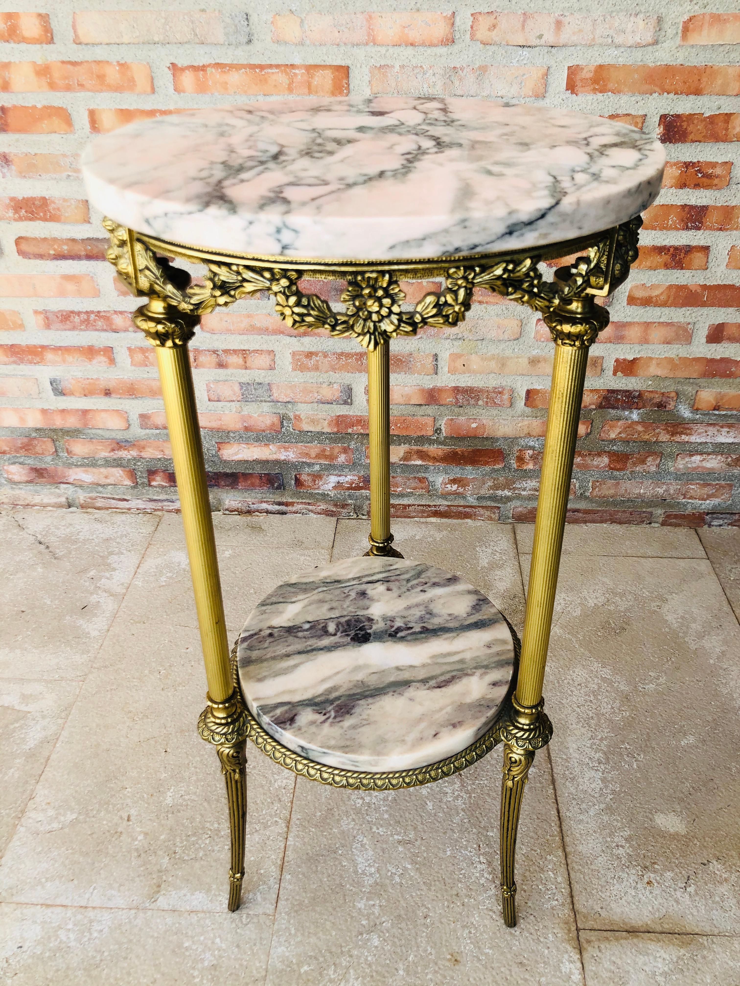 19th century Spanish bronze and brass gilded side table with white marble top
Beautiful bronze reliefs in the base of the top and ornamental motifs in the three pedestal leg.