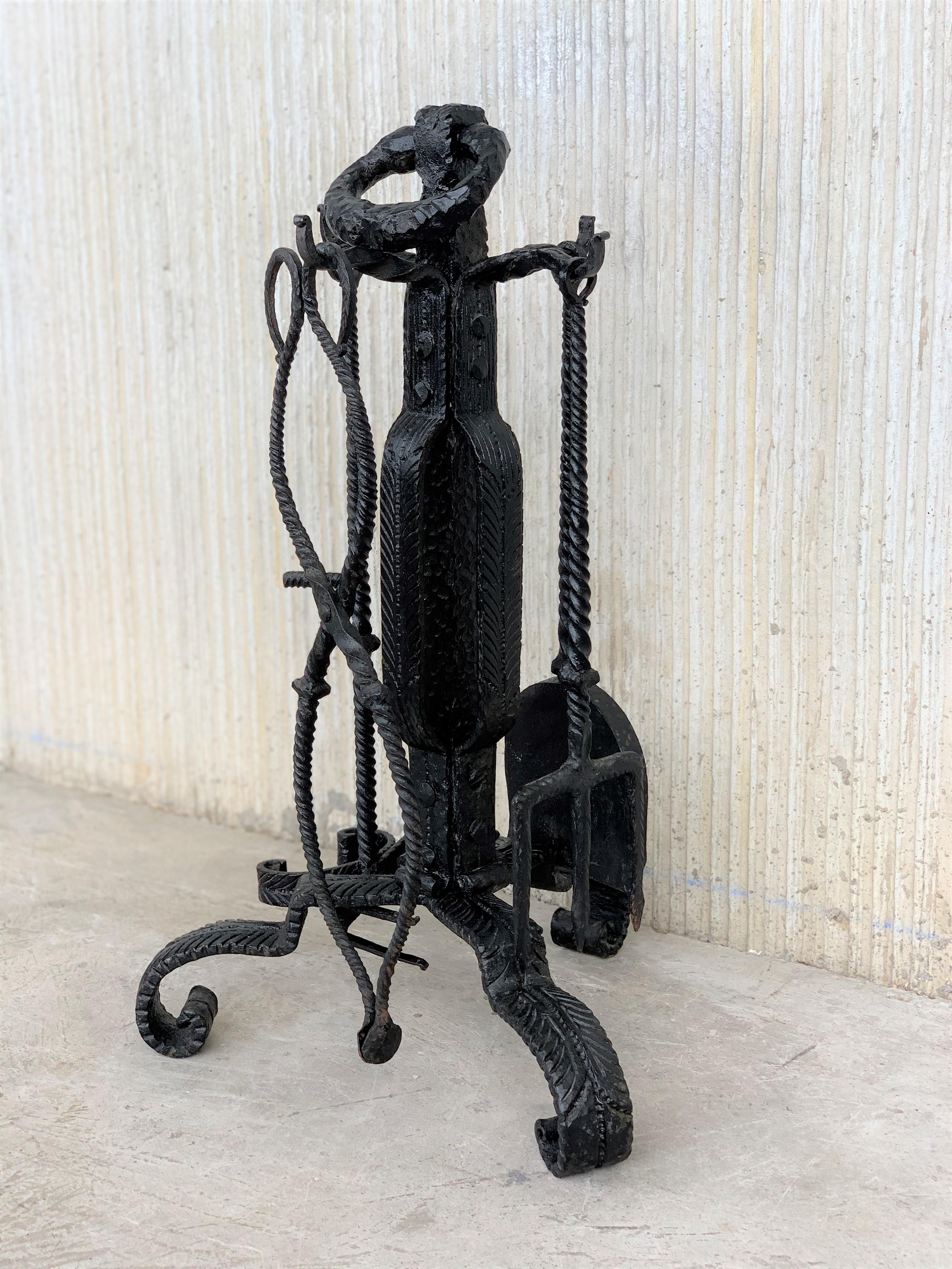Fine handwrought fireplace tool set. 5 pieces. Shovel, poker and a clamp for grabbing the log along with the holder for the tools. All hand forged.