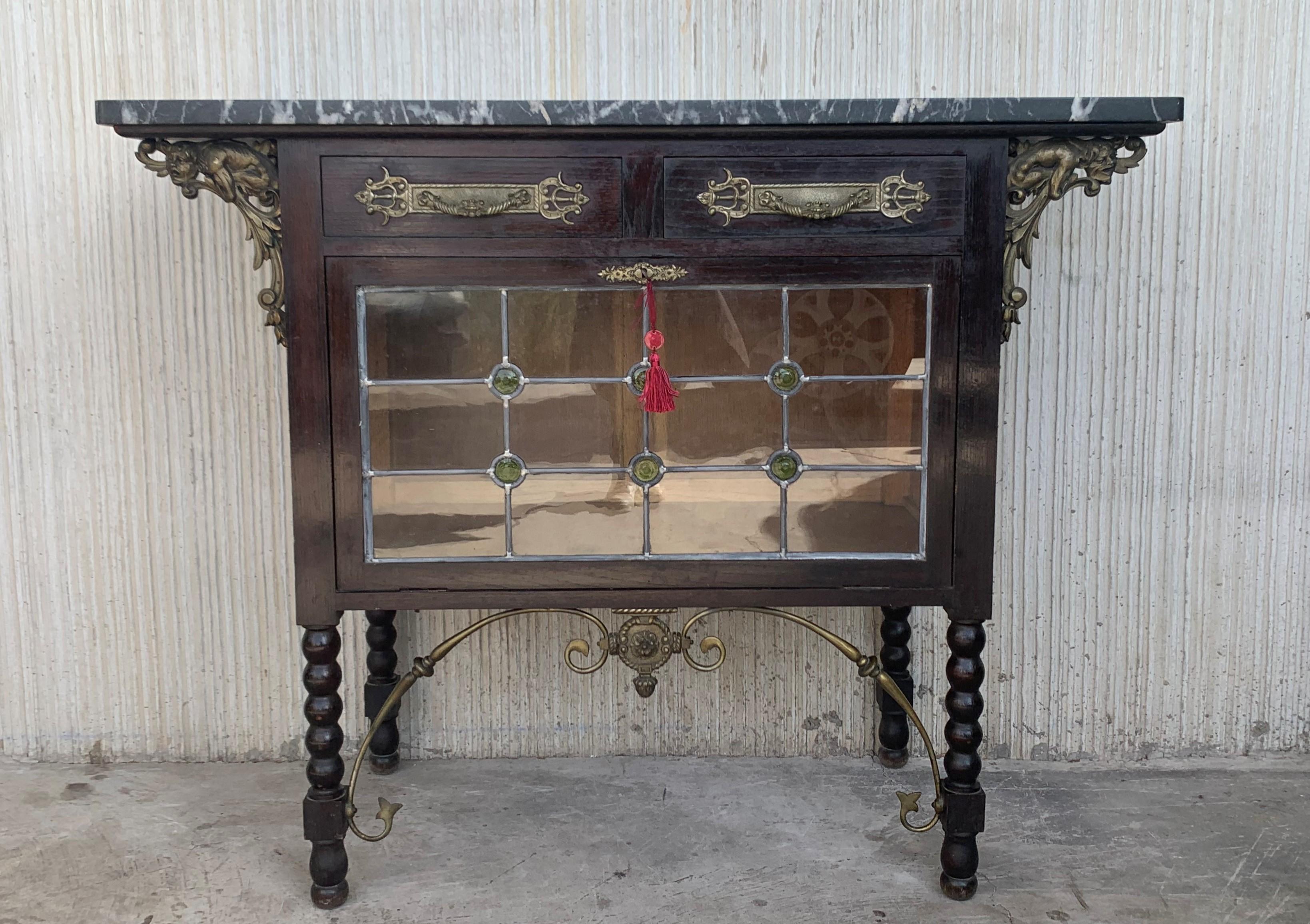 19th century Spanish buffet in walnut and top marble with bronze decorations
It has two drawers and one folding door.

 