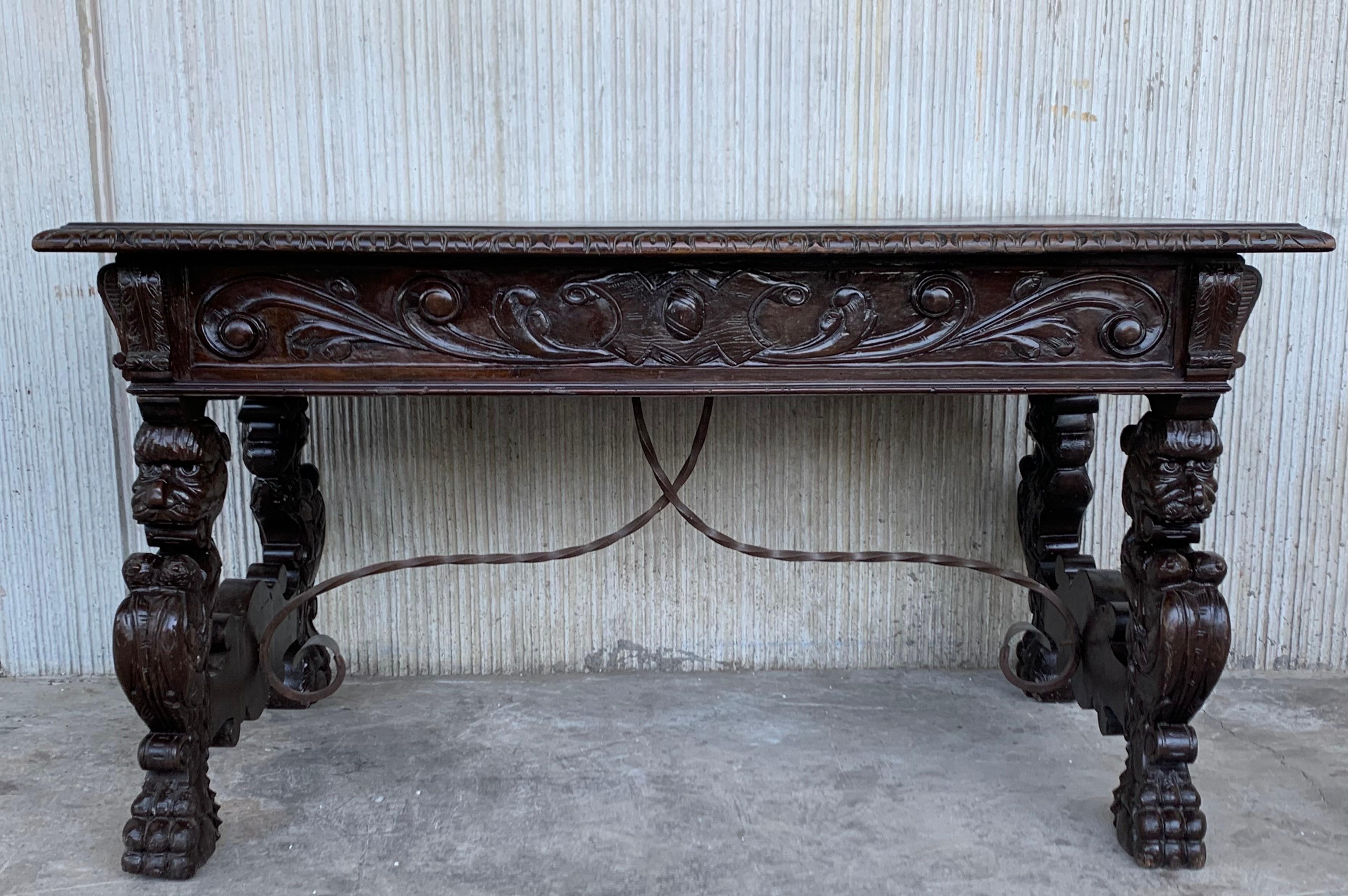 In grand, gothic style, this Spanish library / writing table has a deeply carved edge and this is just the tip of the proverbial iceberg, as the carving never really stops. It goes on from the frieze, down along the shaped pedestals features four