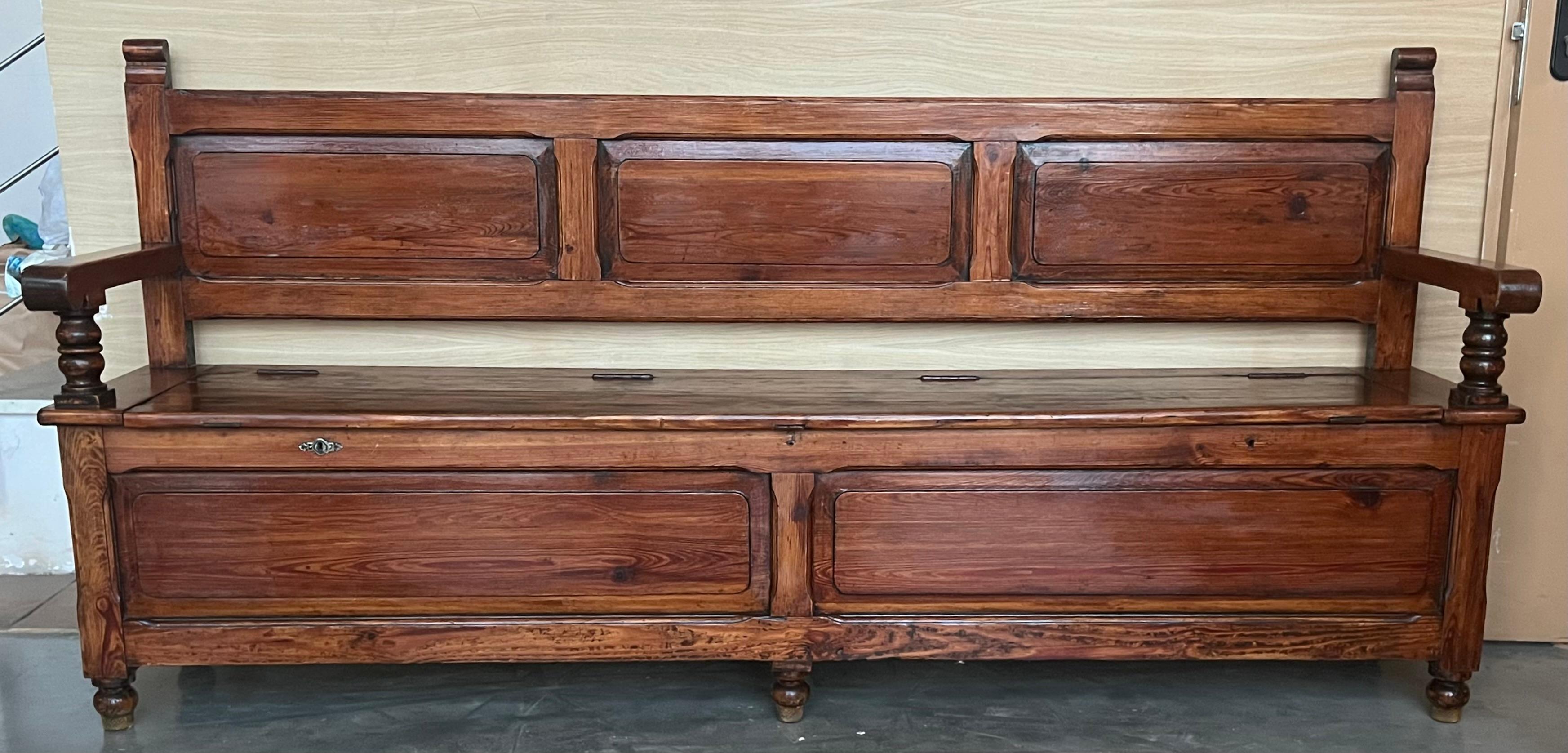 This 19th century mobila bench is richly made with Castilian motifs. Despite its age, the piece has a very solid frame with relatively minor damage. Boards show the evidence of very old tools and techniques. 
It's a heavy bench, very sturdy ,