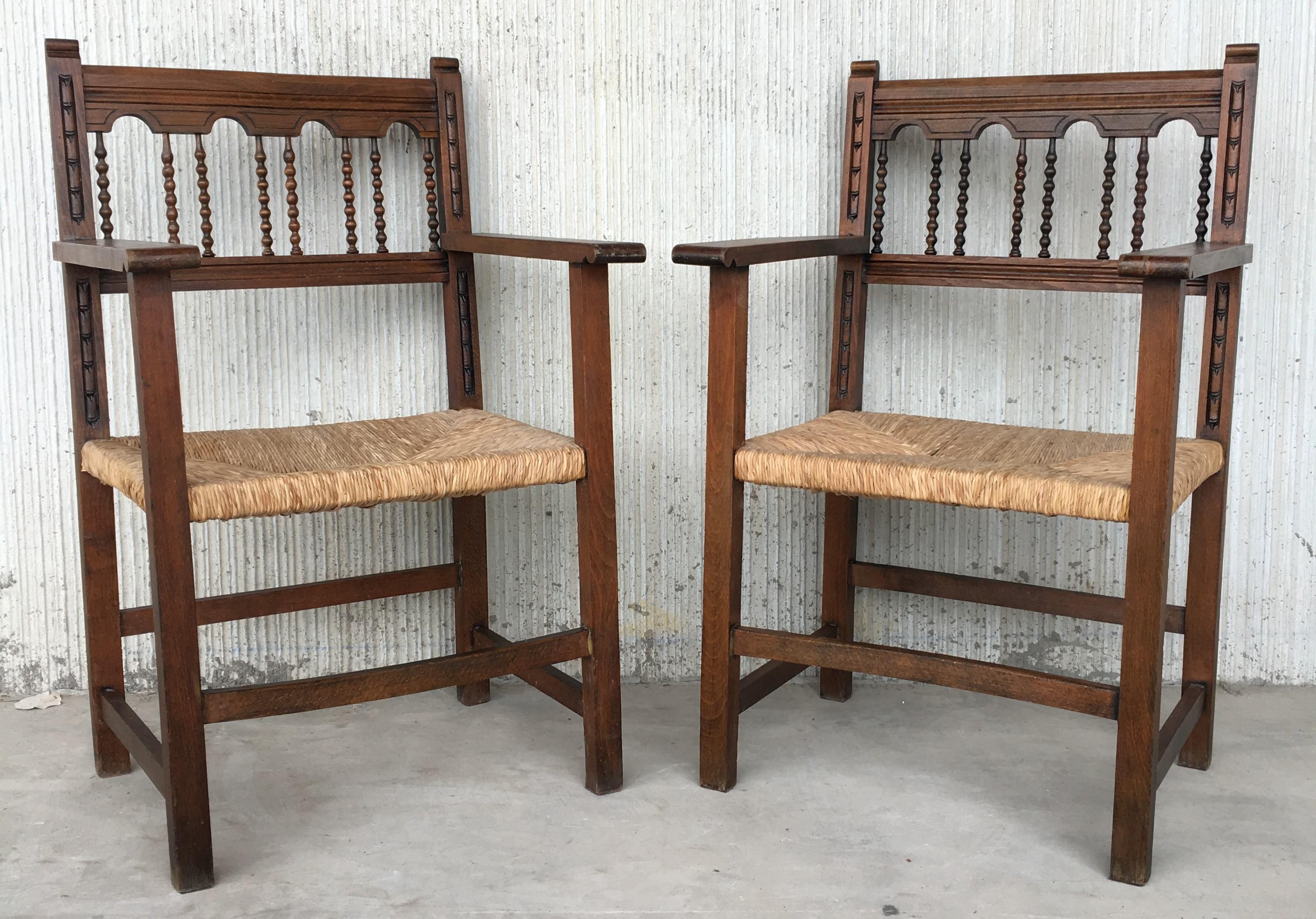 19th Spanish Colonial Altar armchairs with caned seat with ornamental carveds

Measures: Height to arms: 27.75.
