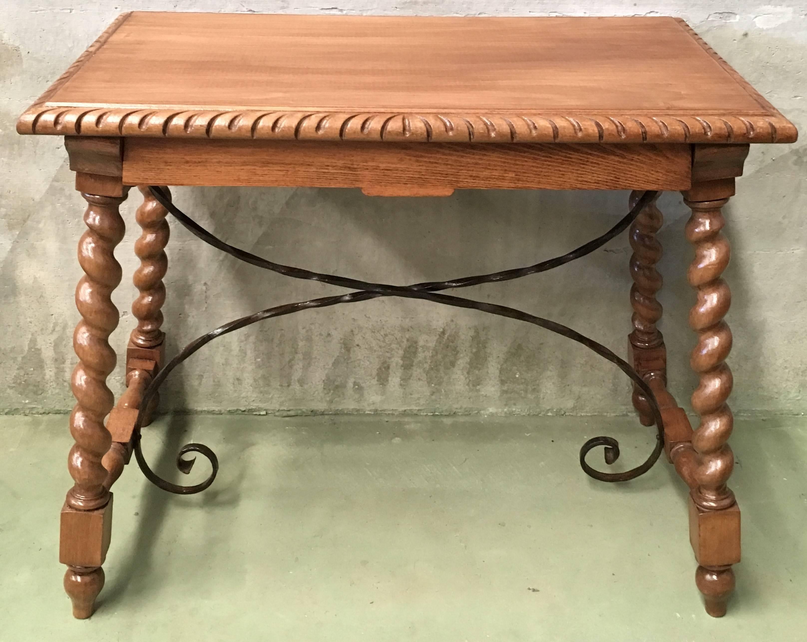 19th Spanish farm table with iron stretchers, hand carved top and drawer.

An unusual form with nice shiny patina. Nice size for a side or end table, or as a lamp table. Graceful carved supports with a shaped edge on the top. The single drawer in