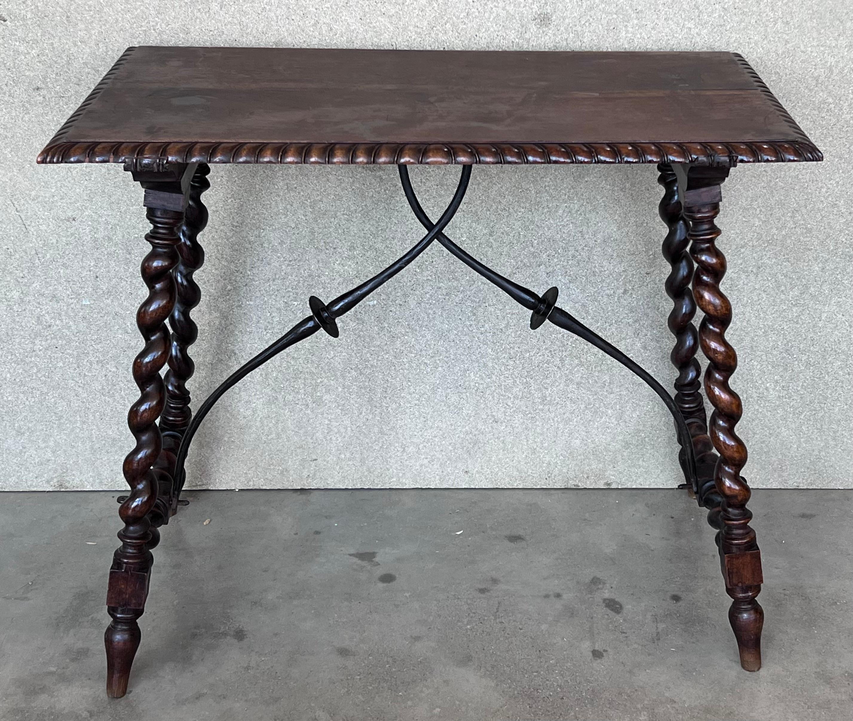 19th Spanish side table with cared Solomonic turned legs and iron stretcher.
The top has a carved edges and a beautiful grain and patina.