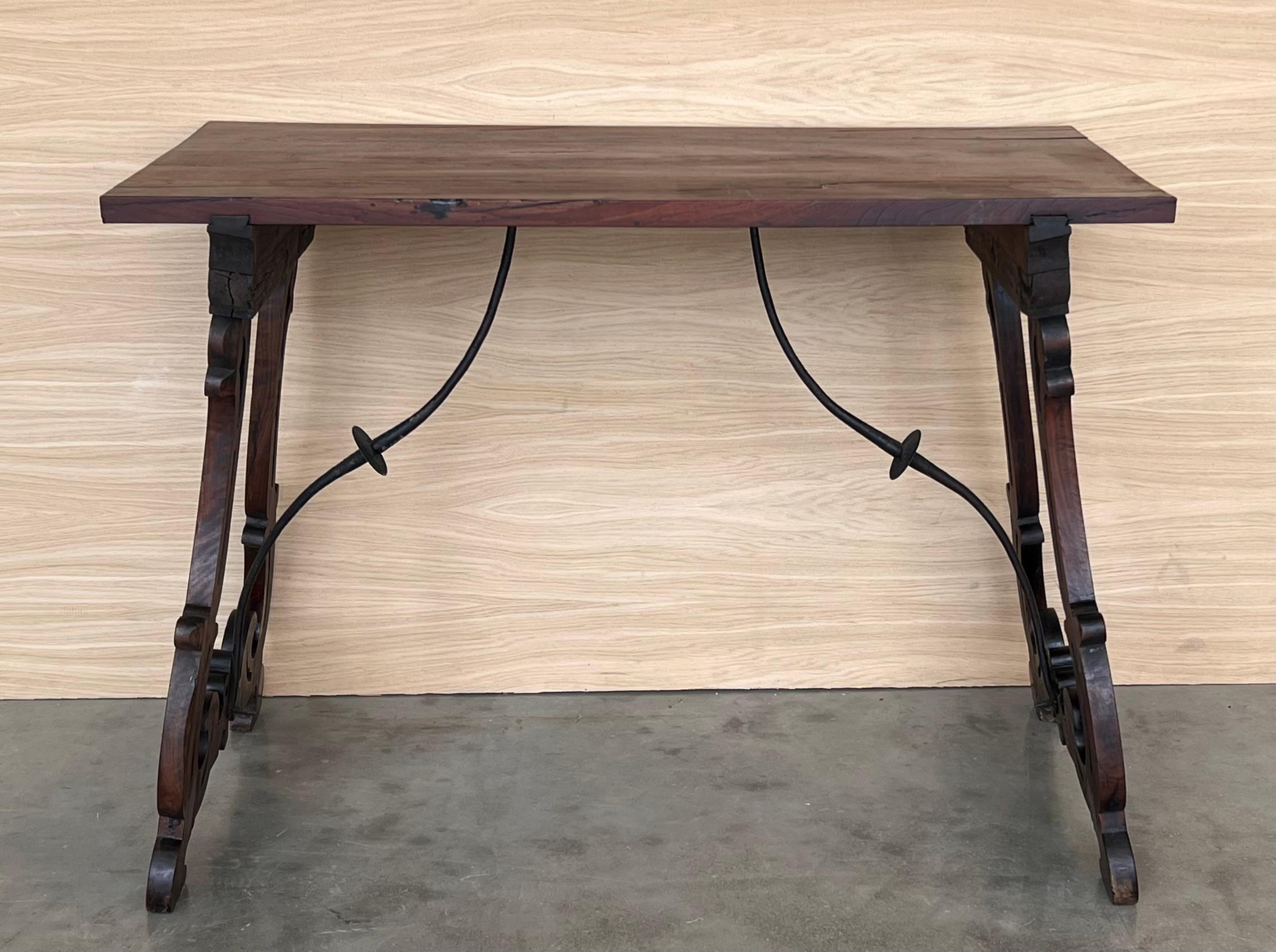 19th Spanish side table with cared Solomonic turned legs and iron stretcher.
The top has a carved edges and a beautiful grain and patina.