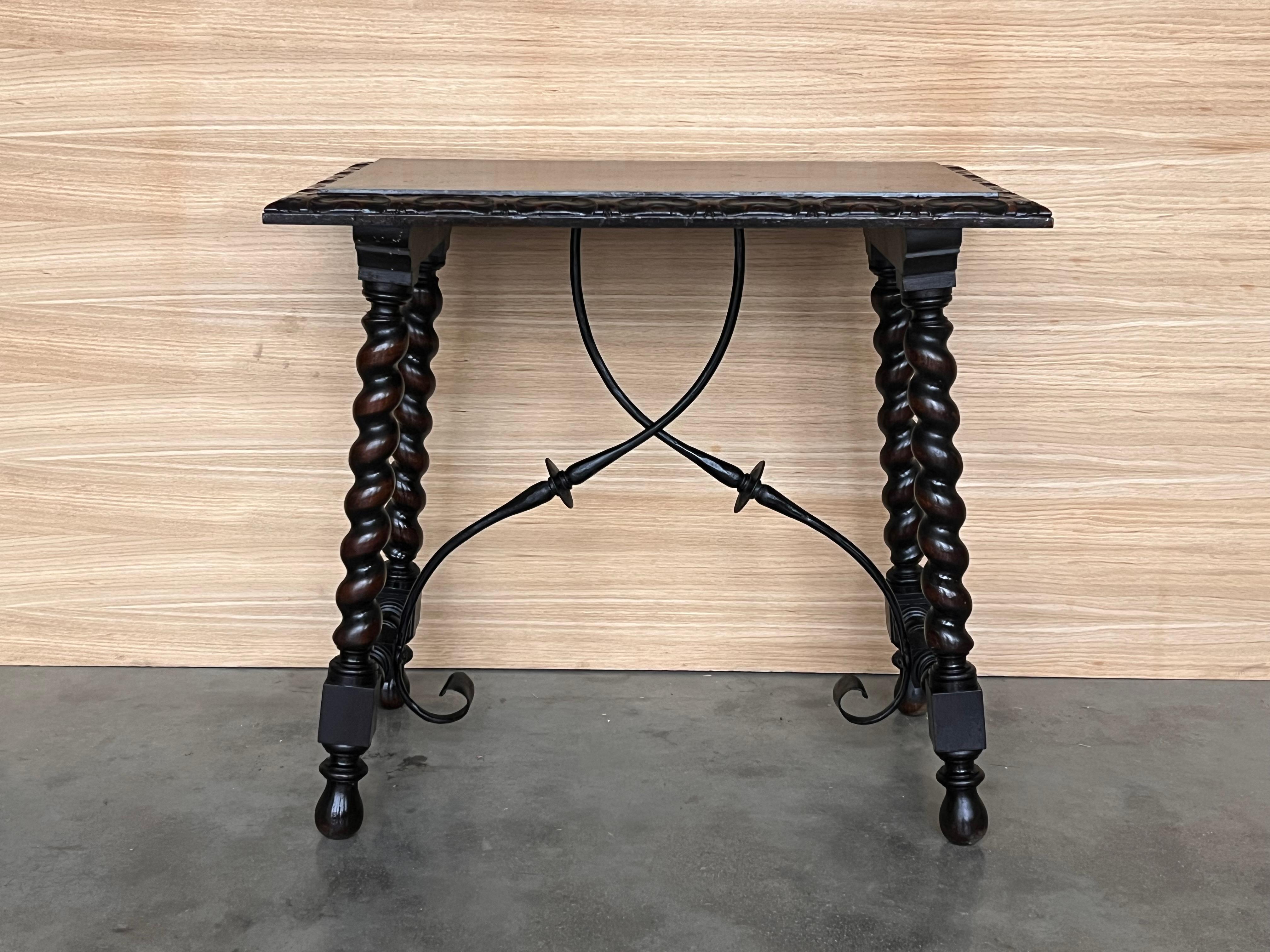 19th Spanish side table with cared Solomonic turned legs and iron stretcher.
The top has a carved edges and a beautiful grain and patina.
