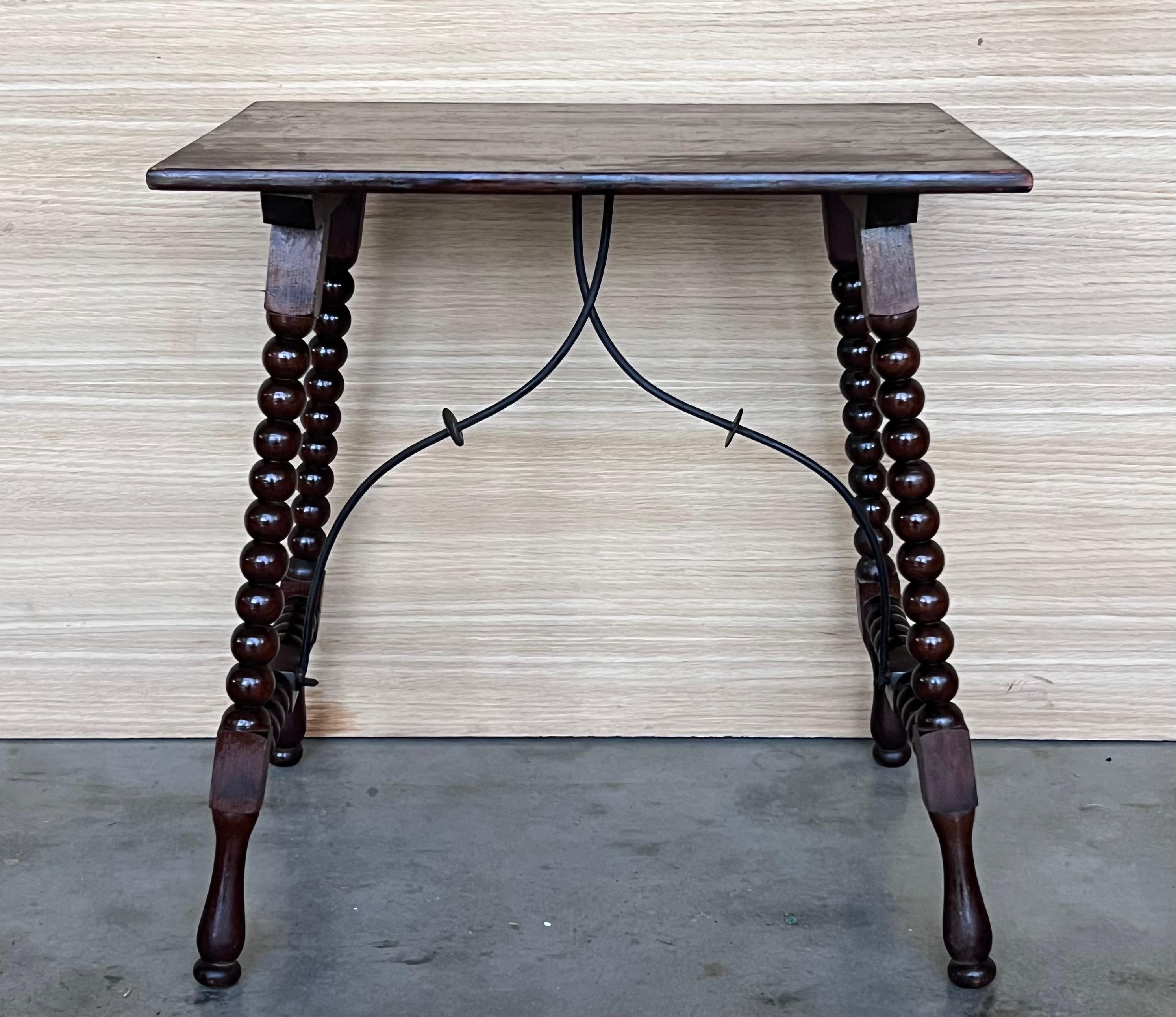19th Spanish side table with turned legs and iron stretcher.
The top has a beautiful grain and patina.