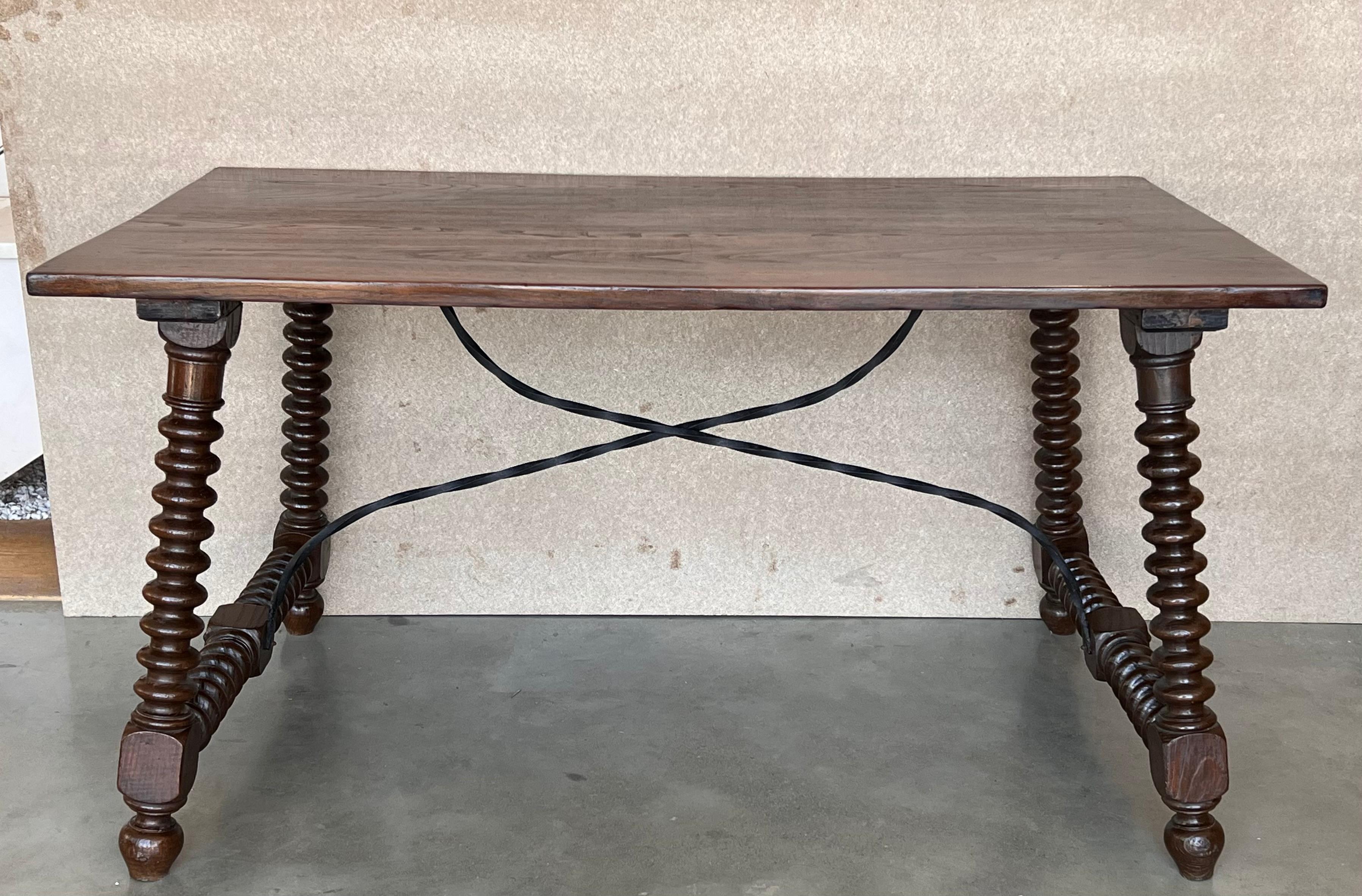 19th Spanish side table with cared turned legs and wood stretcher and also an iron stretcher 
The top has a carved edges and a beautiful grain and patina.