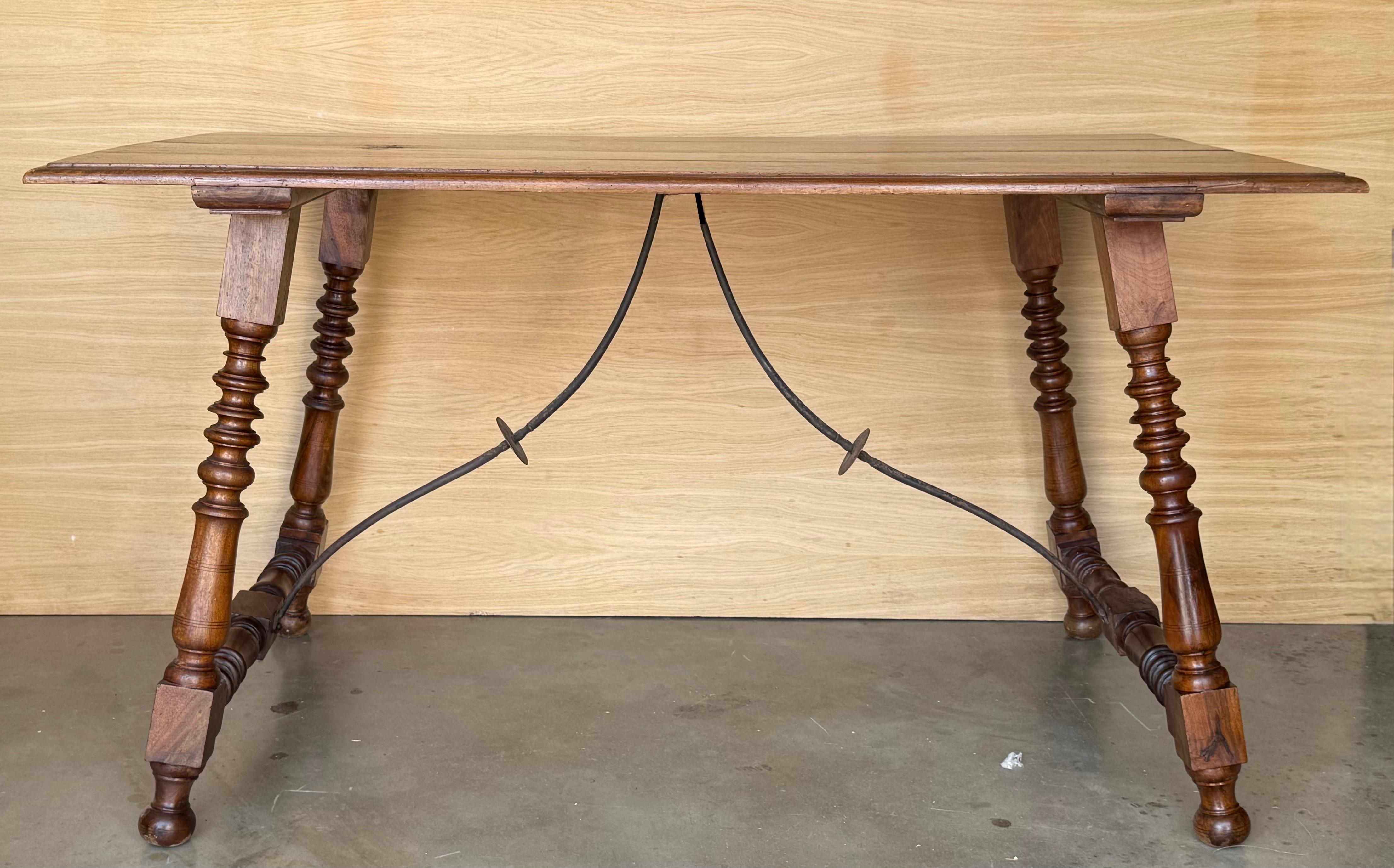 19th Spanish side table with turned legs and double stretcher match in the button top.
The top has a beautiful grain and patina