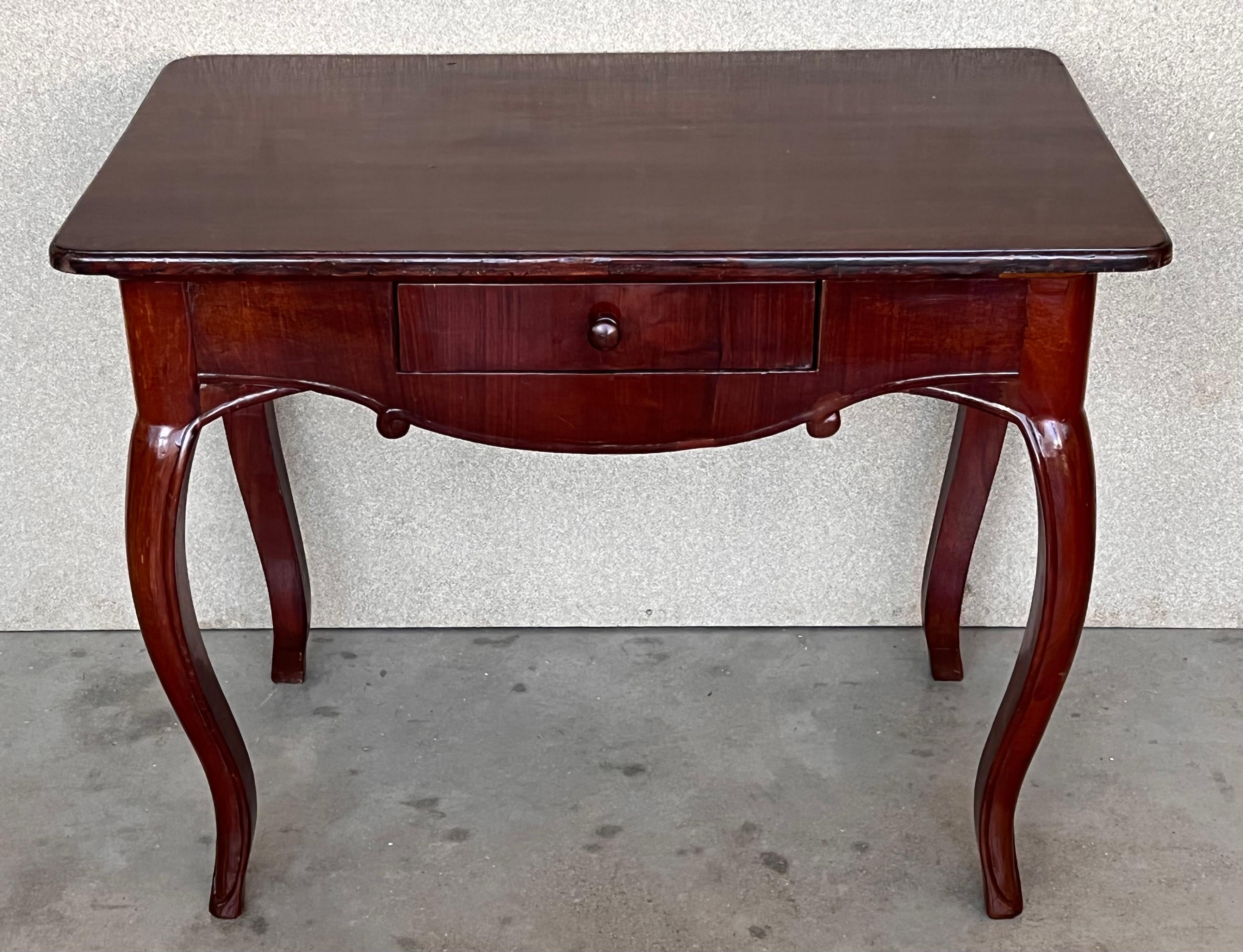 Having a rectangular top with bookmatched solid walnut boards above a case housing one-drawer, raised on square tapering legs.

Measures: Height to the drawer 26.77in.