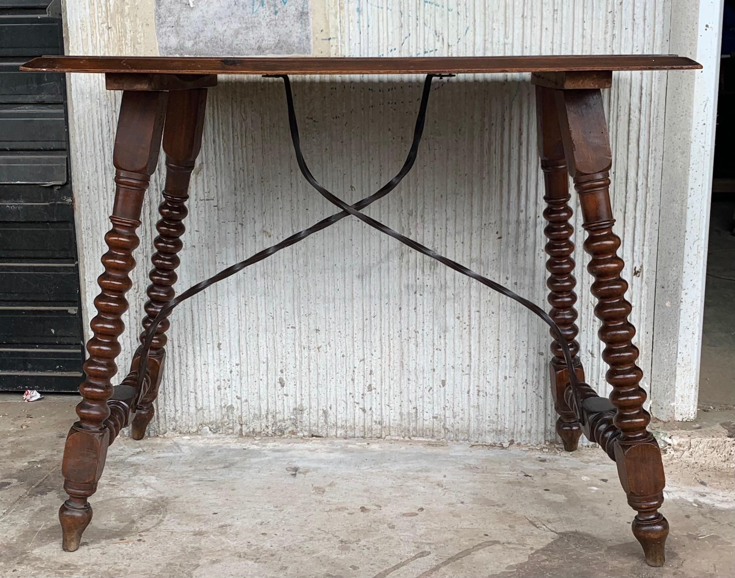 Side table of walnut with turned legs and beleveled top, Spanish, 19th century.