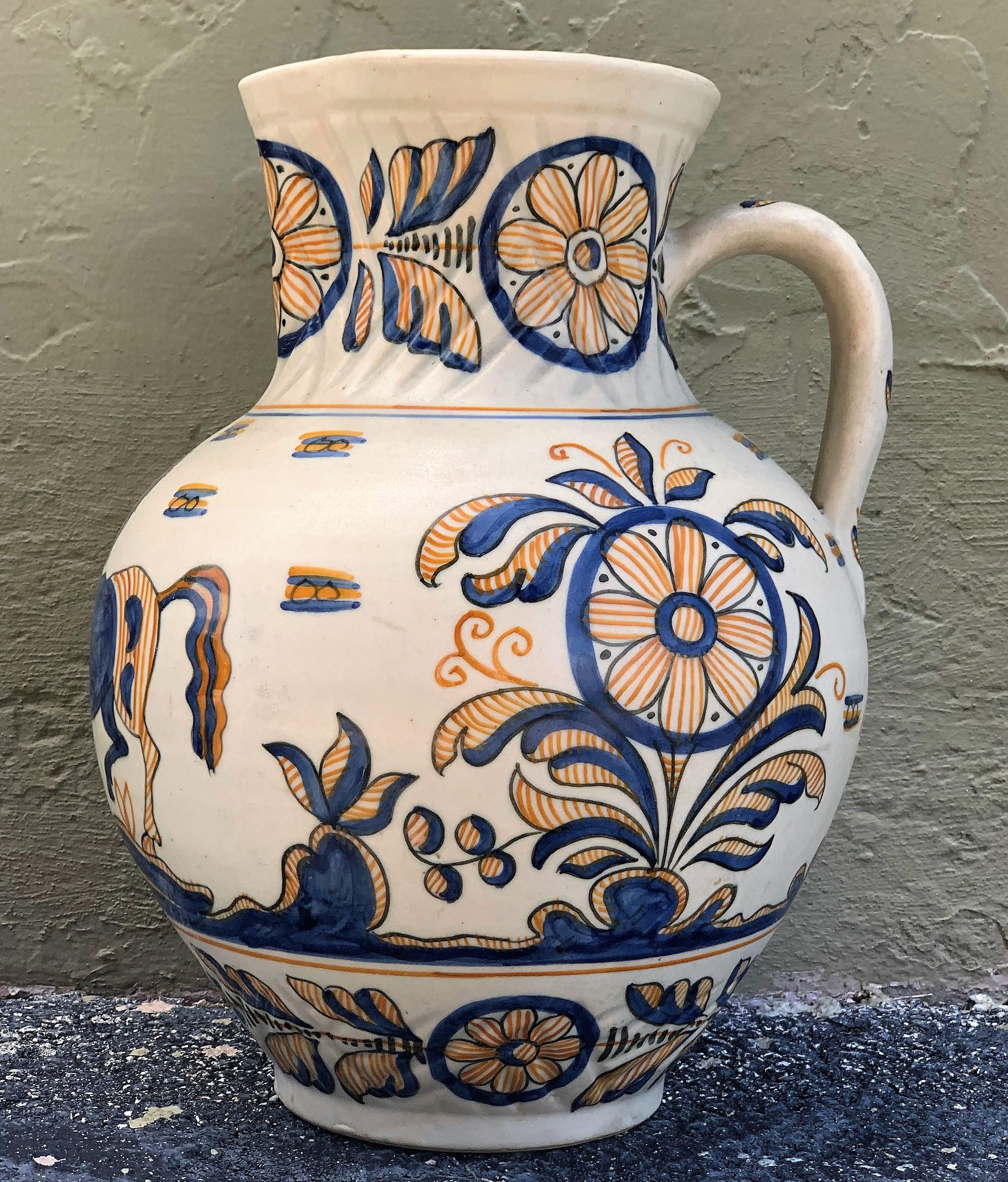 A striking Spanish glazed earthenware two-handled blue and yellow painted urn or vase with molded handle, the body underglaze blue & yellow decorated, 19th century.
