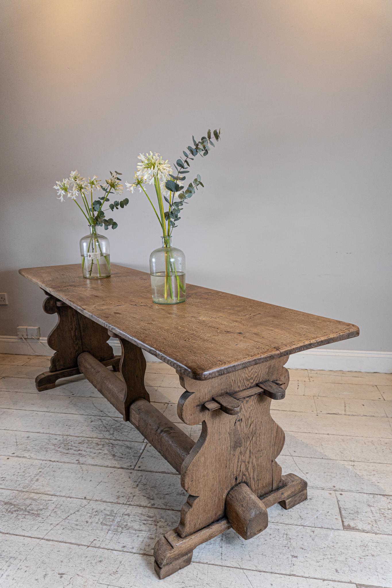 This North Country dining table is made of oak and has a wonderful one plank top.

Almost Scandinavian in feel and style with its decorative side supports and unusual stretcher.
The table although narrow in depth is comfortable to sit at and will