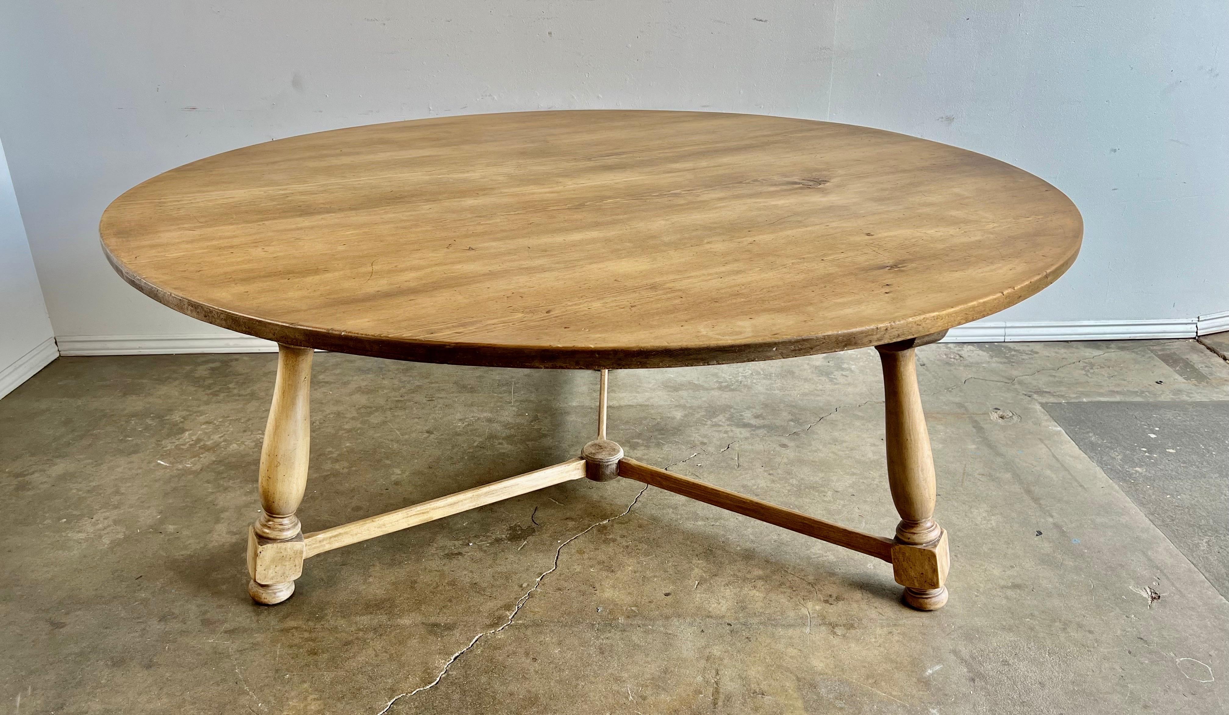 19th c. Swedish round shaped dining table. The table stands on a tripod base connected by a center stretcher. The table has a light bleached natural looking finish. It is a great table for any style decor.