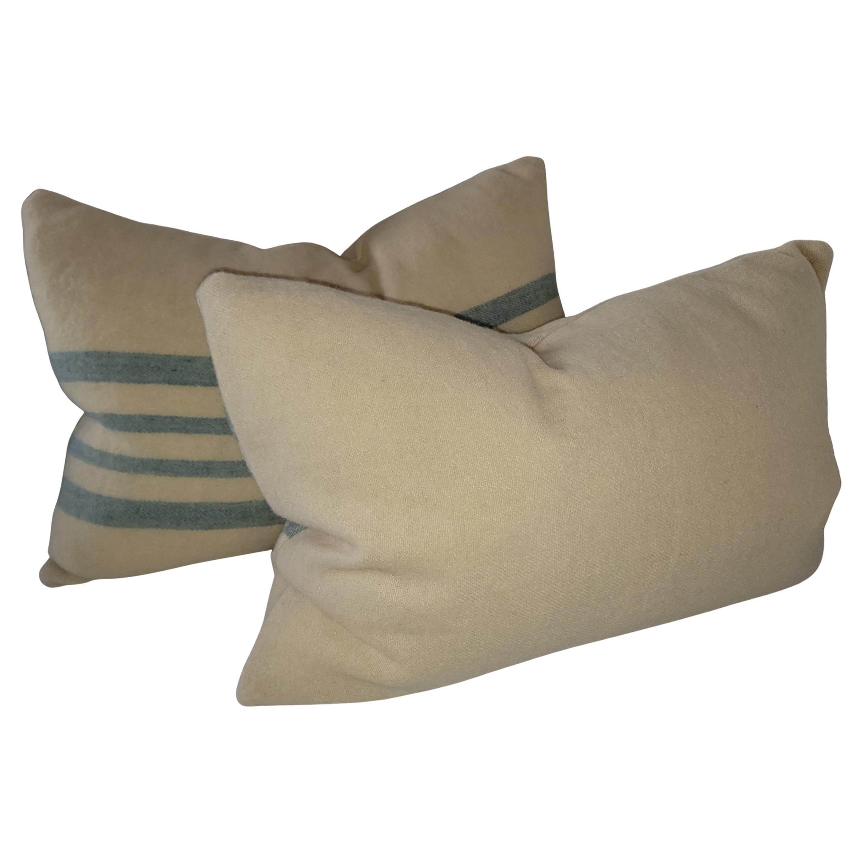 Coperta artigianale in lana d'agnello del XIX secolo con cuscini bolster a righe azzurre. Gli inserti sono in piuma e piumette. Venduta in coppia.
2 paia disponibili.
