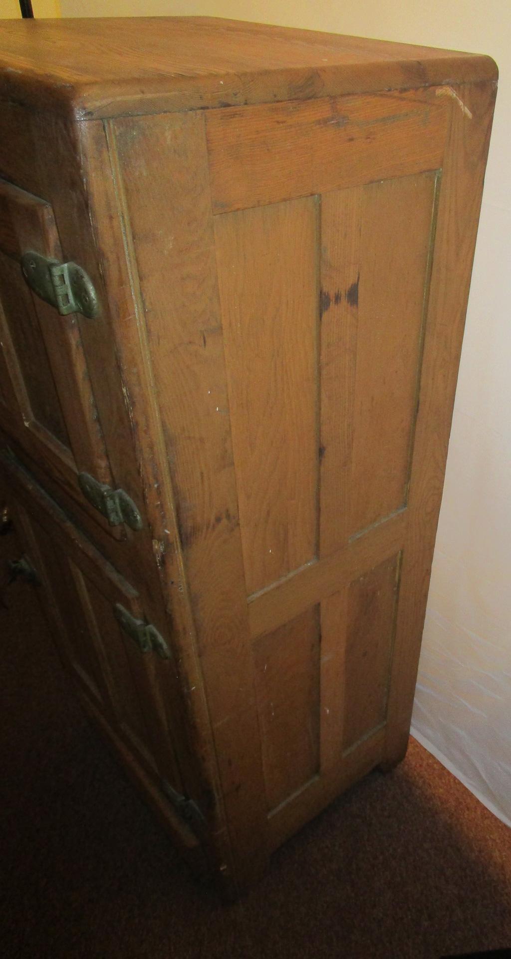 This Antique ice box or cooler is constructed from solid oak and was the refrigerator of the late 1800s and early 1900's.

The front top door opens to reveal a metal lined compartment where large blocks of ice would be placed to cool the unit. The