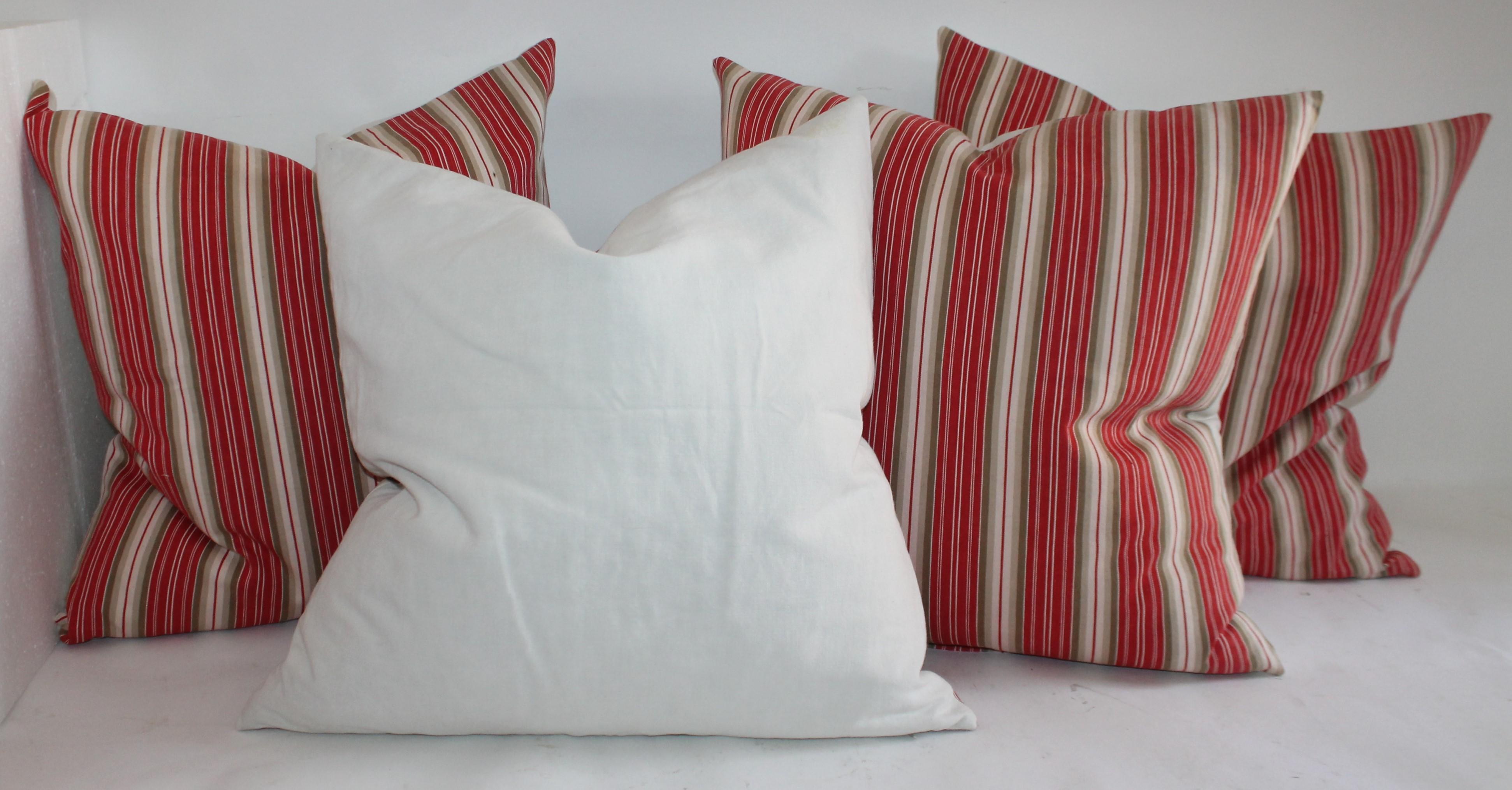 These American rare stripe ticking pillows have homespun linen backings. There are two pairs in this collection and in pristine condition. The inserts are down and feather fill.