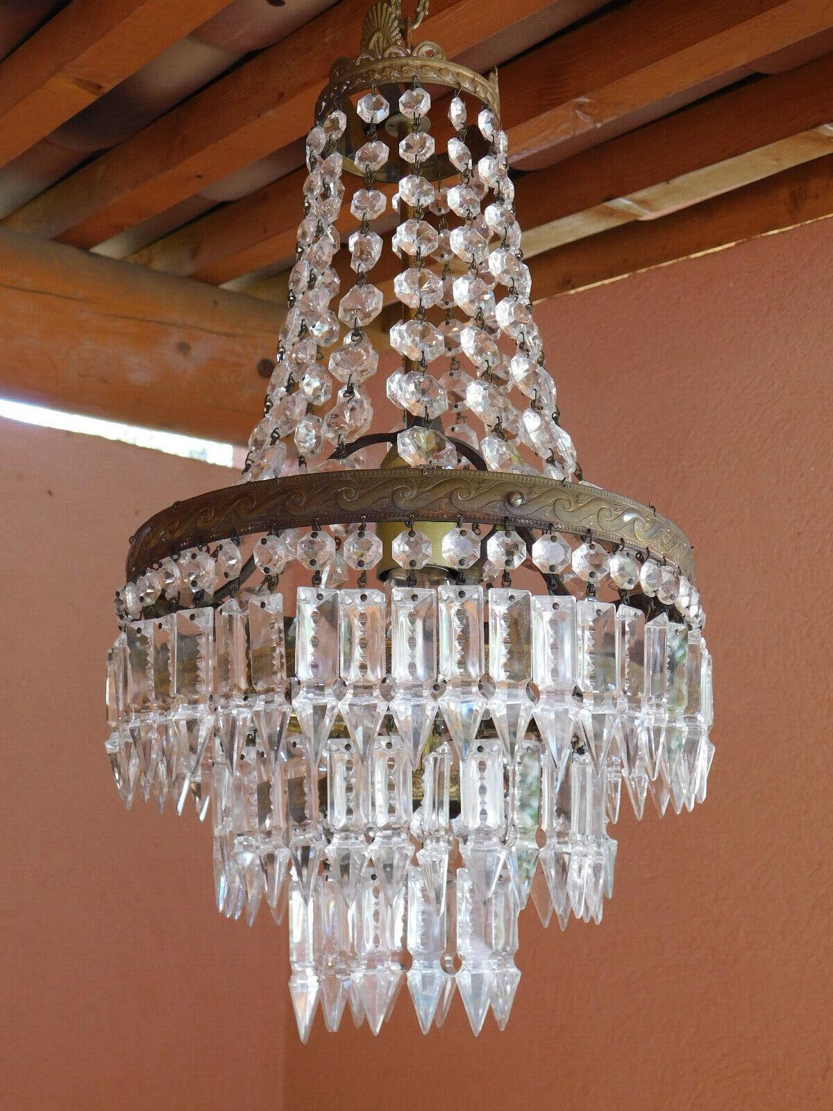 19thc French Empire style Bronze and Crystal Chandelier. Cascading crystal form. Bronze frame. Purchased in France.