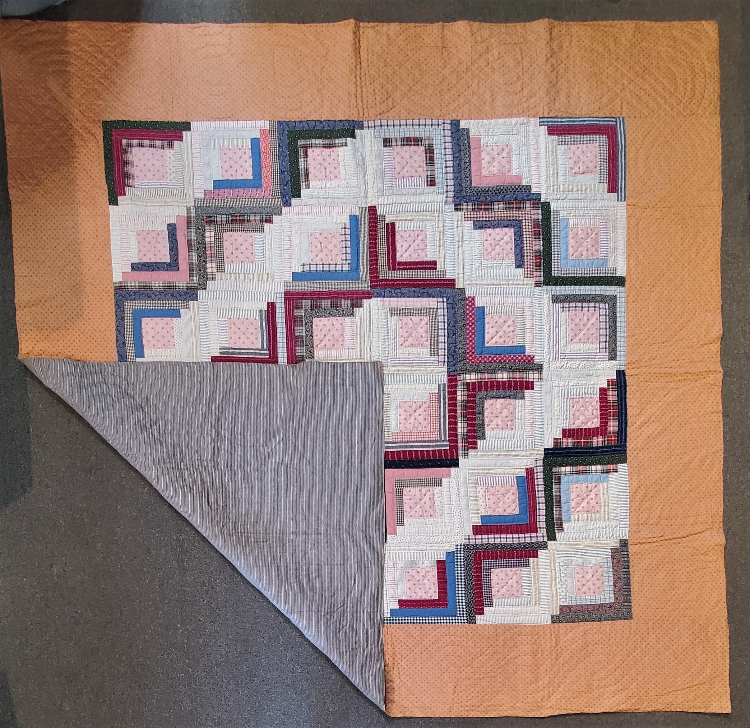 This finely made cotton Lancaster County ,Pennsylvania log cabin / barn raising quilt. The colors are a soft spring colors.