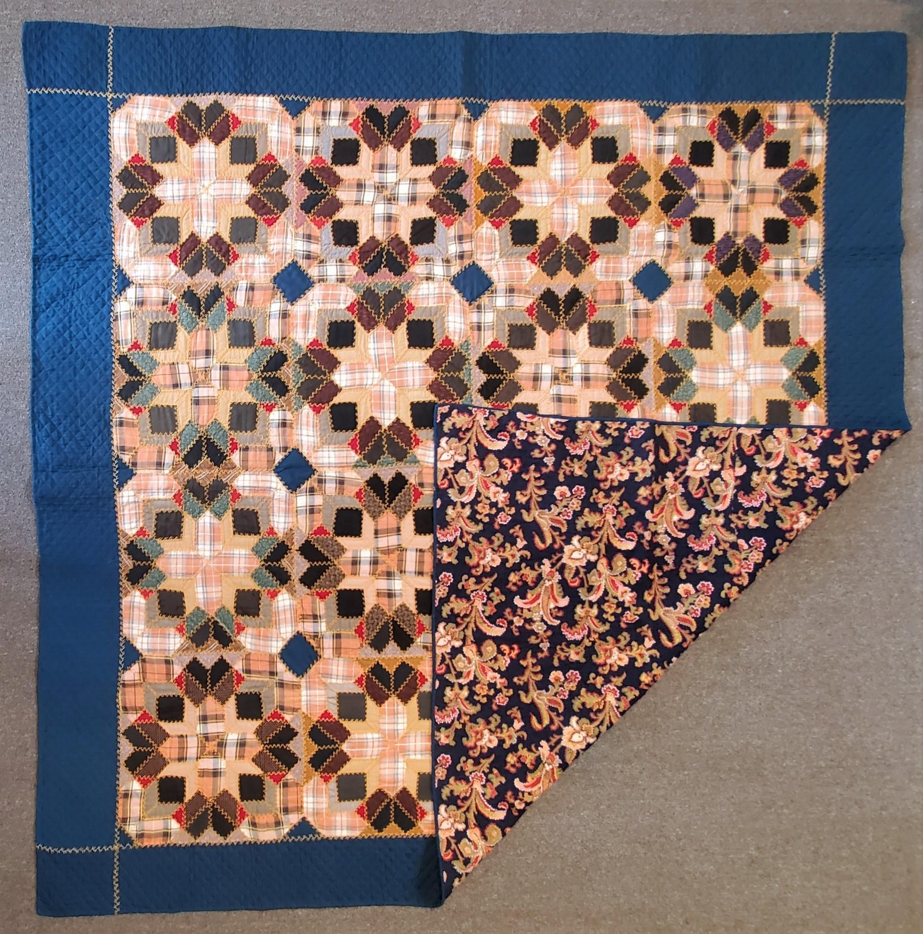 This super amazing wool plaid pieced stars is in mint condition. The surround stars have embroidery around the blocks. The backing is a floral wool backing.The border is a teal blue wool and very nicely quilted. This quilt is from a private