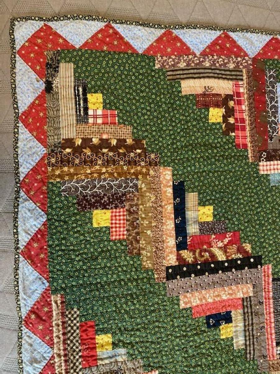 This fine hand pieced & quilted barn raising / log cabin crib quilt is in very fine condition. It has been professionally laundered and remains pristine.