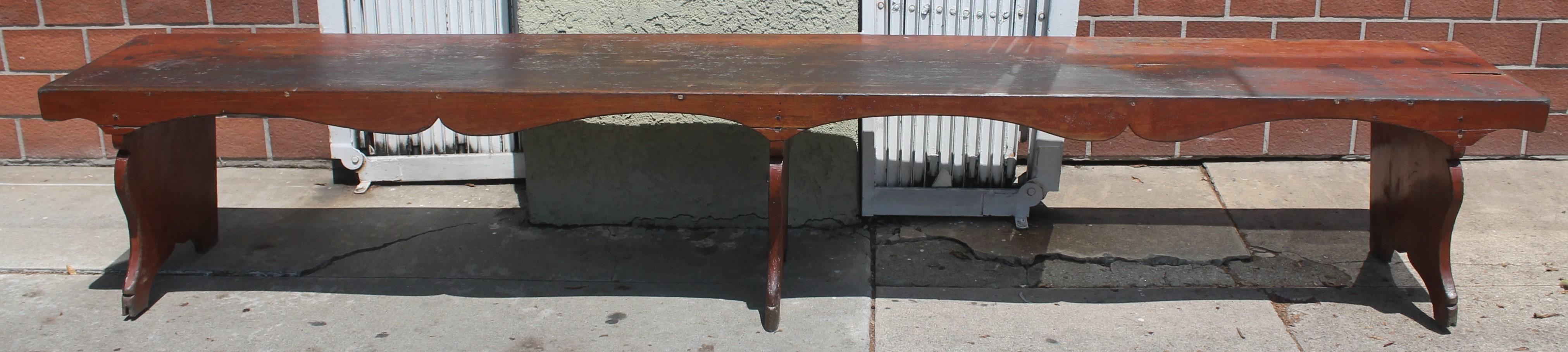 19thc original painted bitter sweet farm house bench with plank seat top. Amazing cut outs and cut out legs. This big bench is so sturdy and strong.