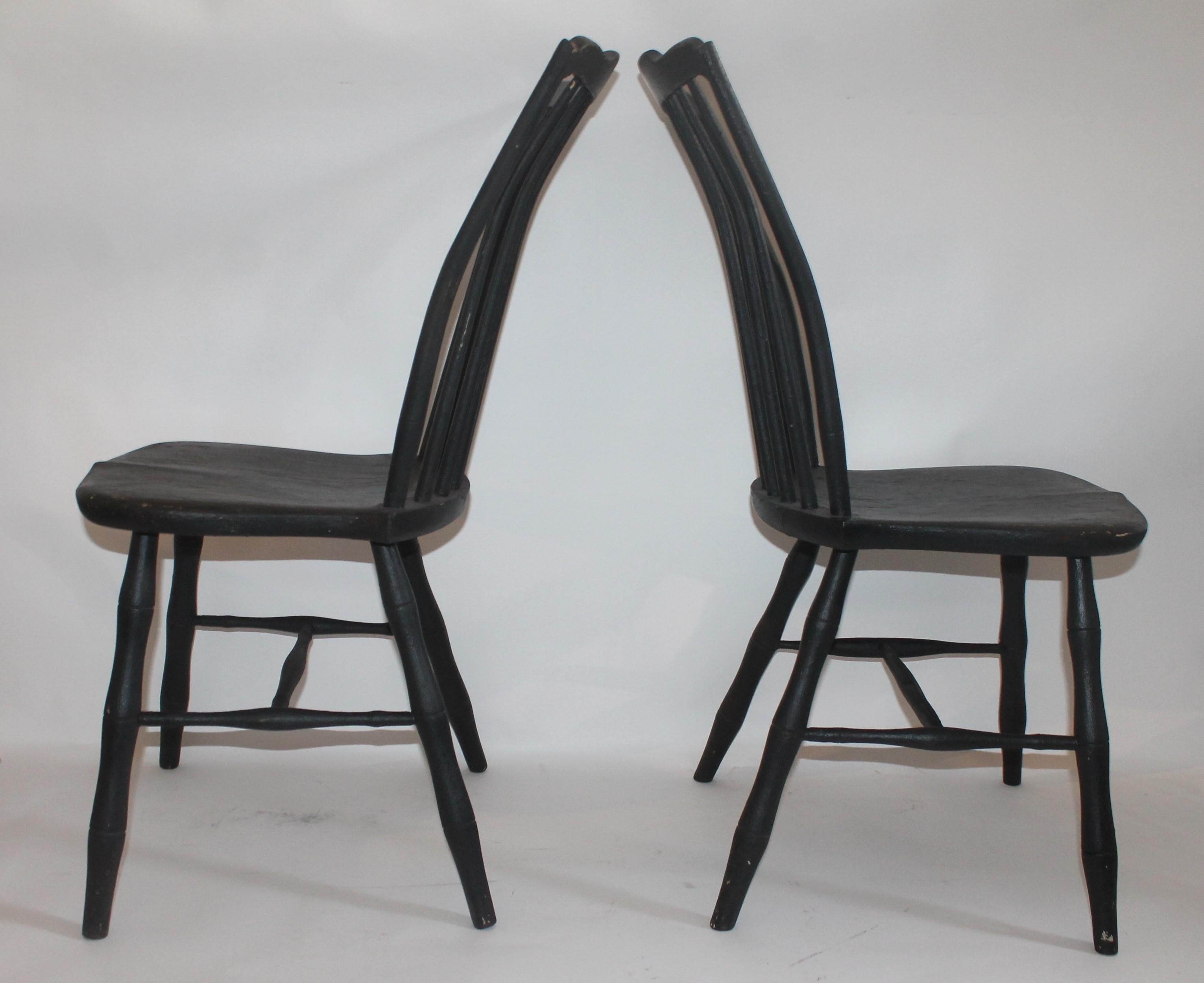 Pair of Windsor chairs with a second generation coat of paint. The wear on the over paint shows the original cream colored paint underneath. Both chairs have been tightened for strength and stability.