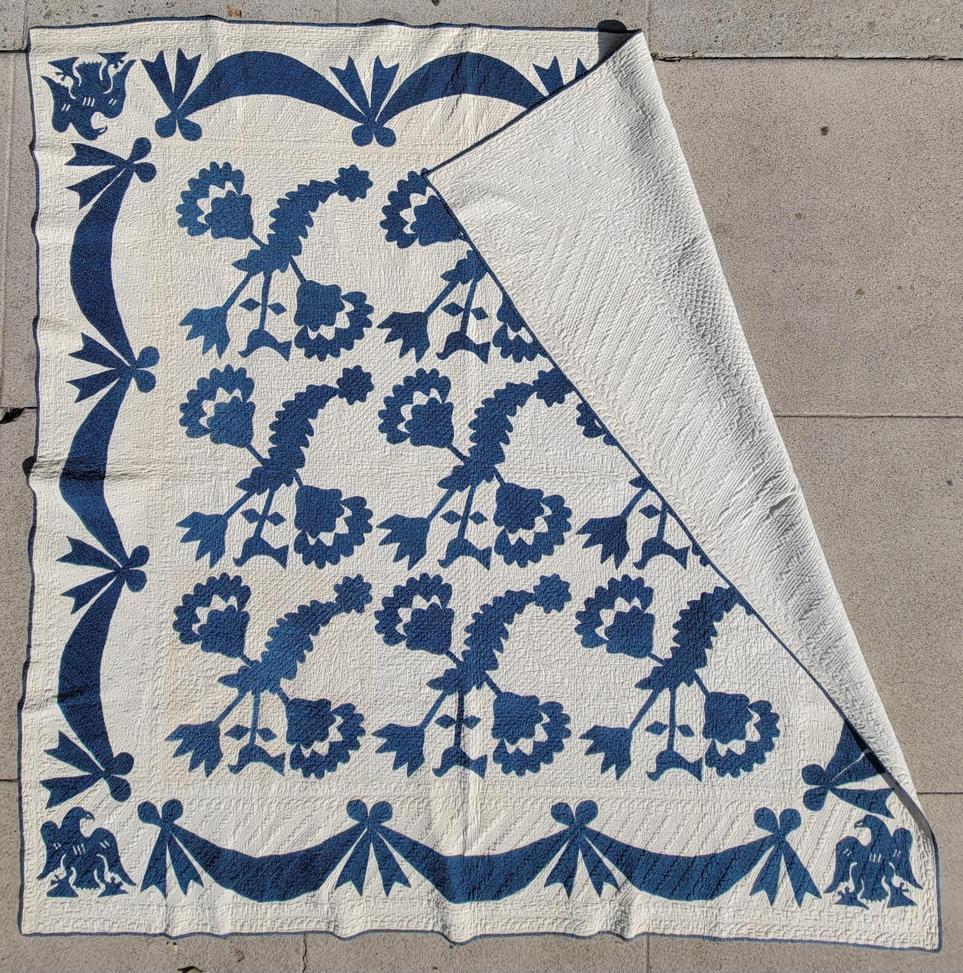 19th century Blue & white floral applique quilt with birds and eagles in all four corners.This early applique is pre -centennial. The condition is very good and the quilting is perfection. The applique work is very tight stitches and very finely