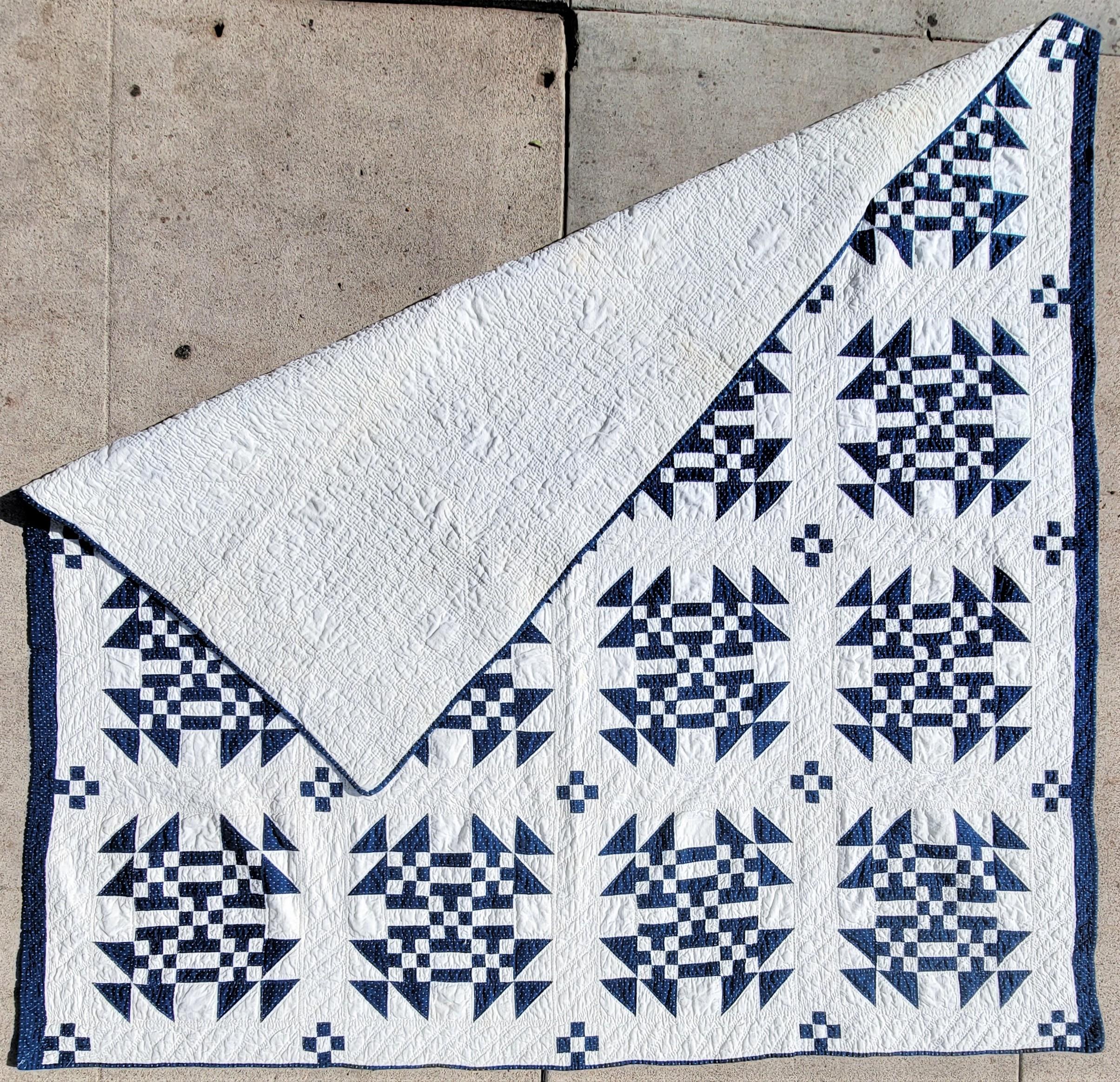 This 19thc blue & white geometric nine patch quilt is from Pennsylvania. The condition is very good.