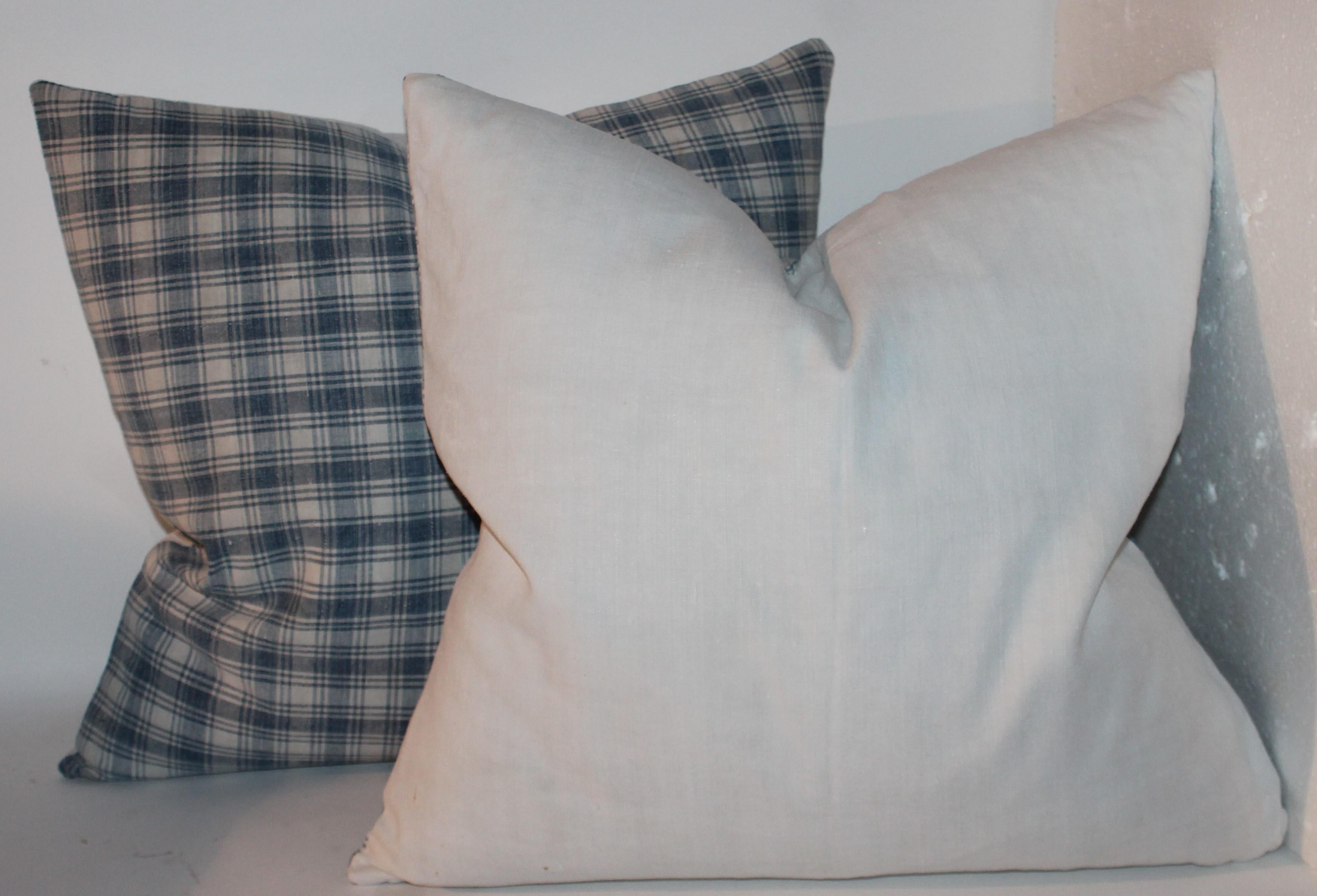 19th century blue and white linen pillows with white linen backings. Down and feather fill. Sold as a pair.