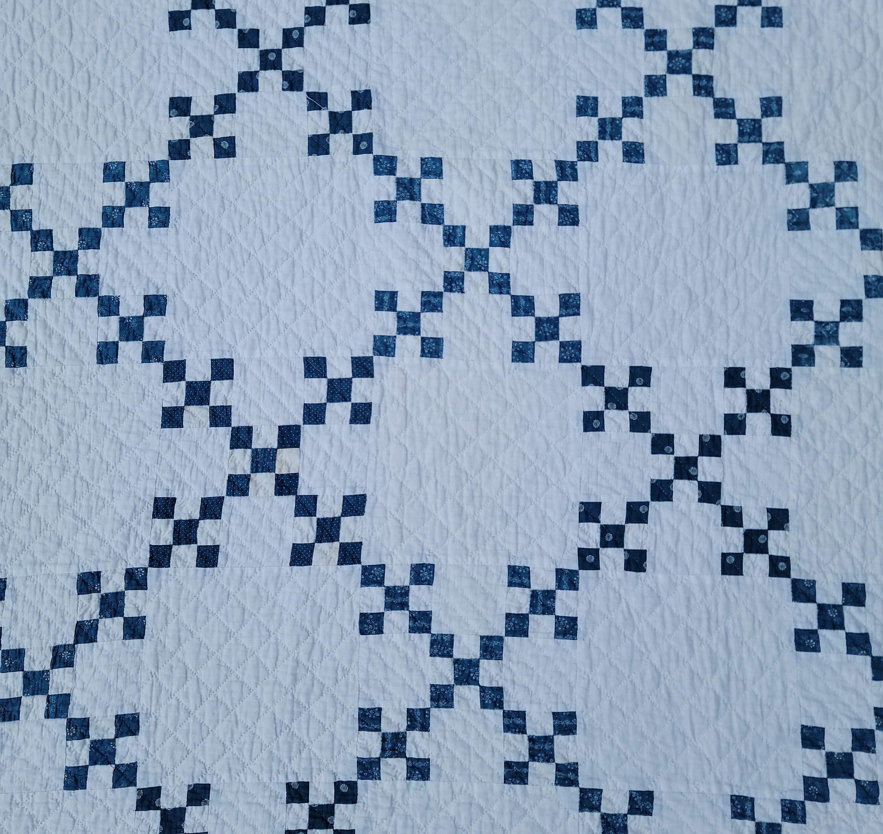 This 19th century blue & white postage stamp quilt is in pristine condition. It has been professionally cleaned.