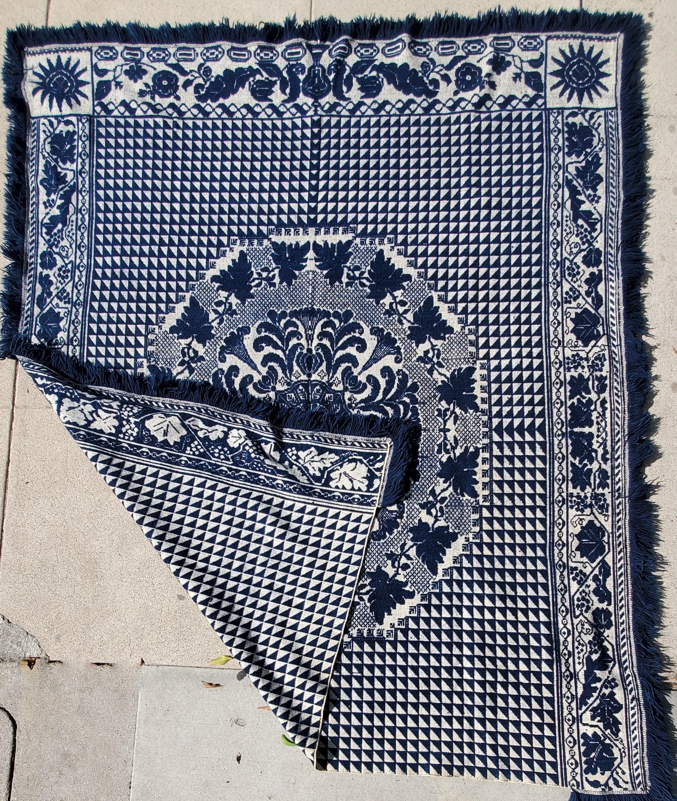 This fine original fringed indigo & white jacquard coverlet from Pennsylvania is in fine condition. It has a flying geese or birds in flight pattern similar to a quilt. It dates from 1850-1860 and was found in a private collection in Lancaster